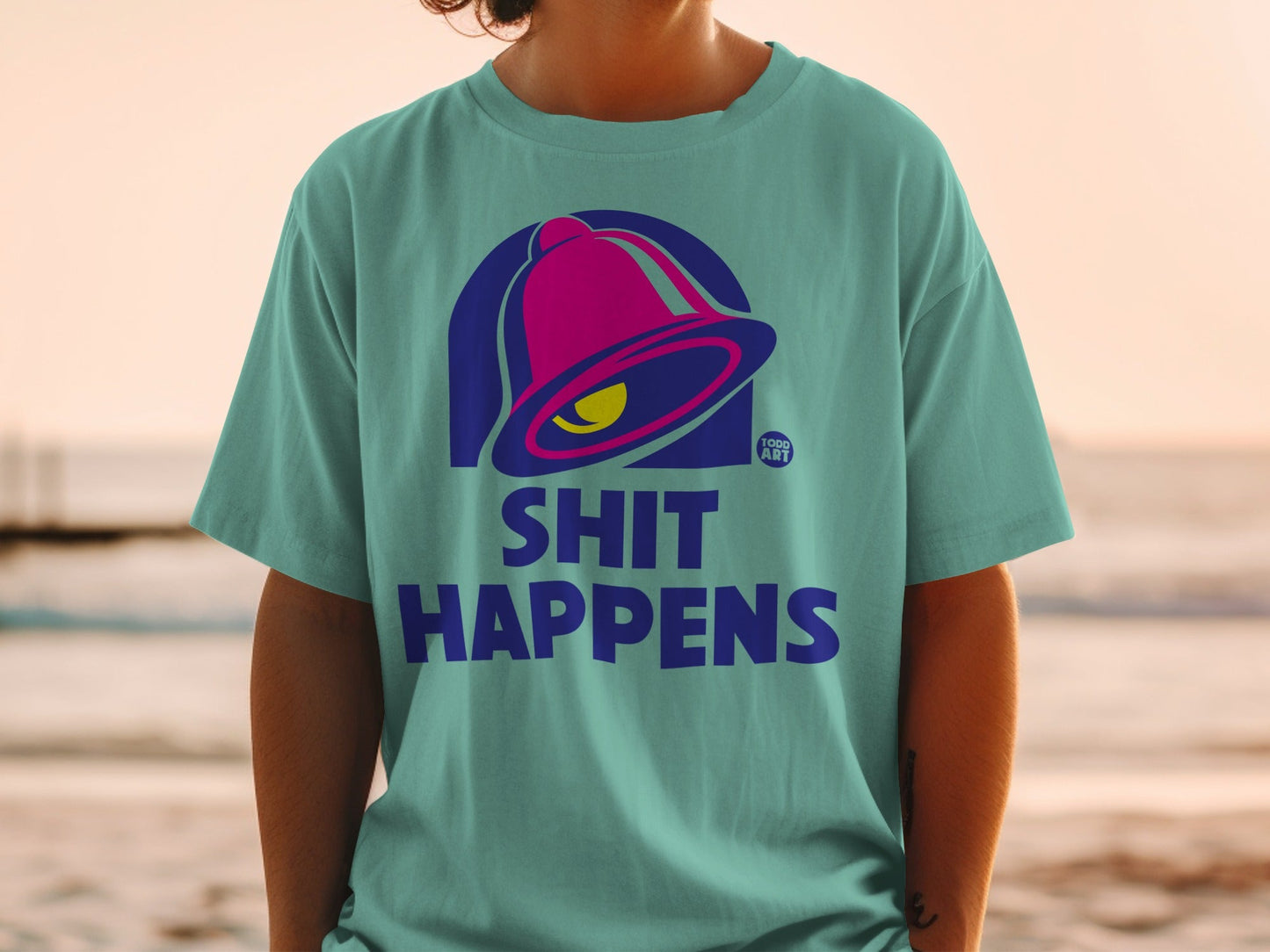Teal t-shirt with Taco Bell logo and "SHIT HAPPENS" text.