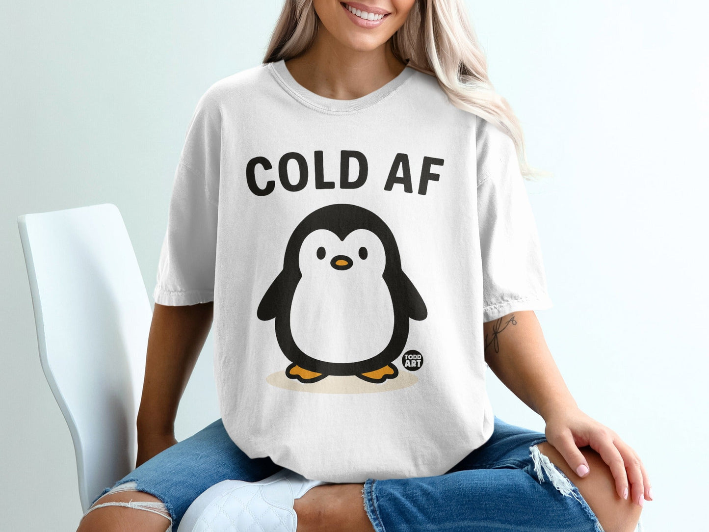 T-shirt with a cartoon penguin and "COLD AF" text.