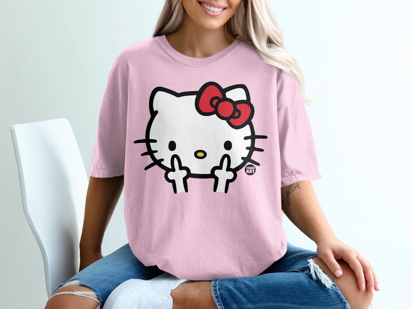 Hello Kitty graphic t-shirt with middle fingers raised.