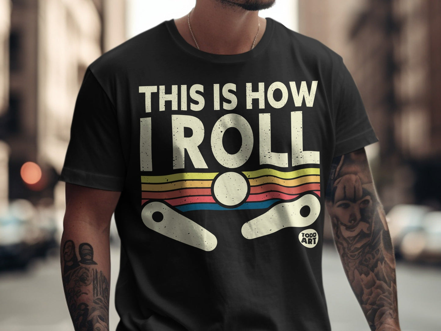 Black t-shirt with "THIS IS HOW I ROLL" text and pinball graphic.