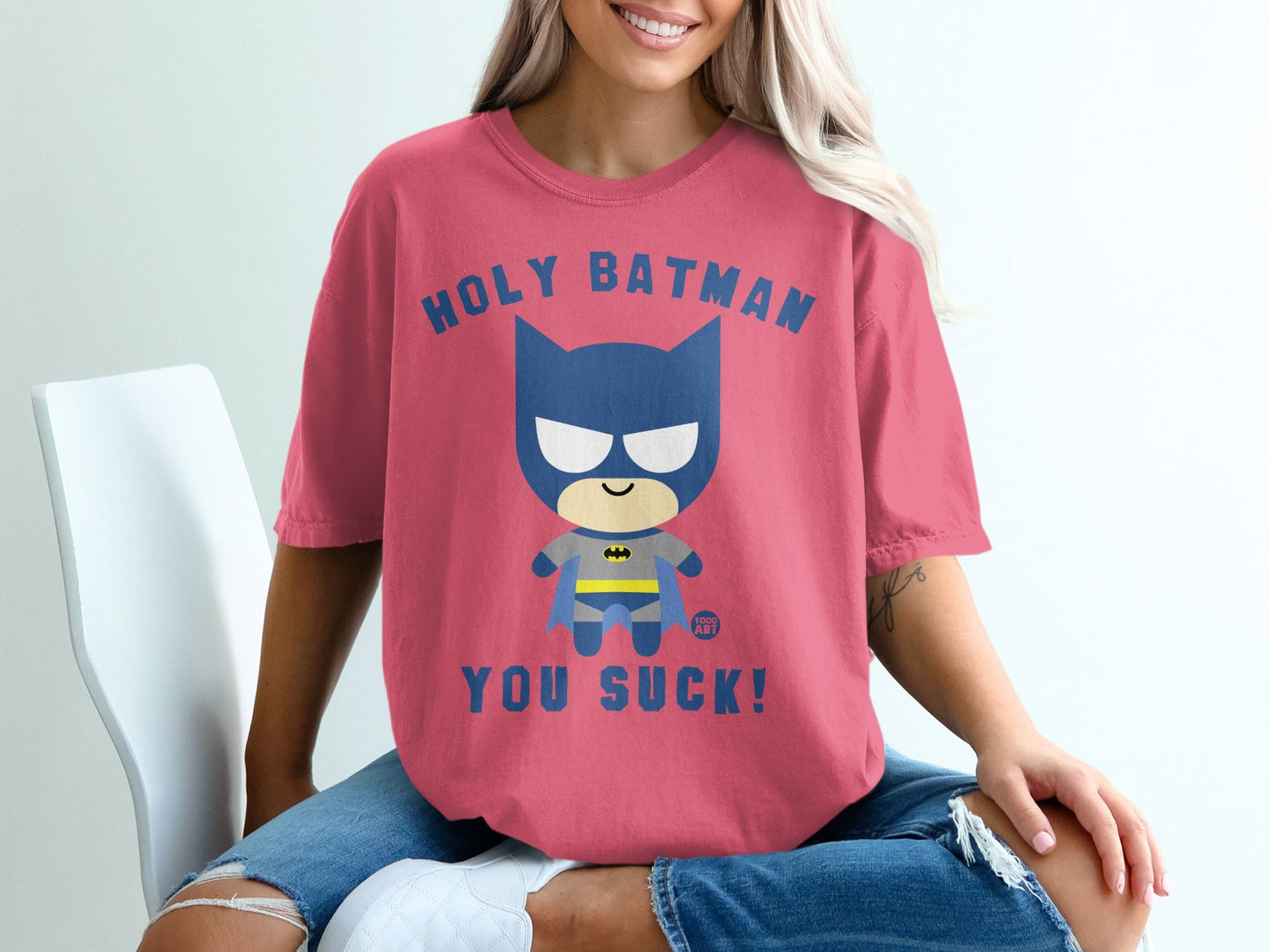 Pink t-shirt with "Holy Batman, You Suck!" text and cartoon Batman graphic.