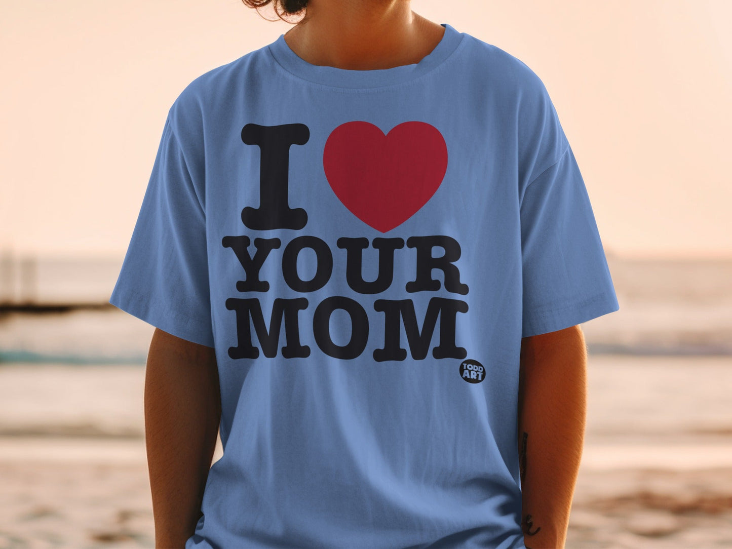 Blue t-shirt with "I ‚ù§Ô∏è YOUR MOM" and a small "GOOD ART" logo.