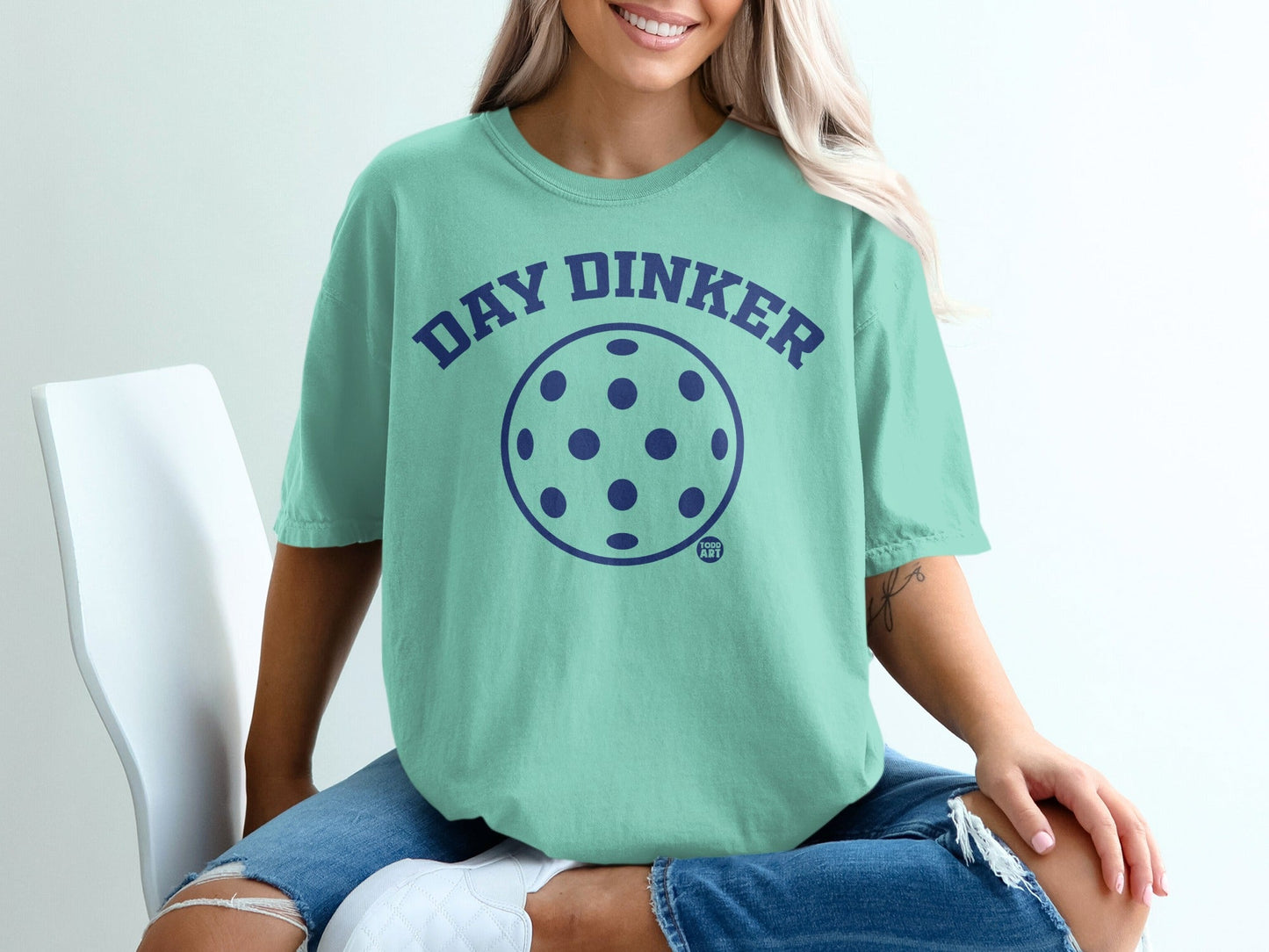 Teal t-shirt with "Day Dinker" text and a pickleball graphic.