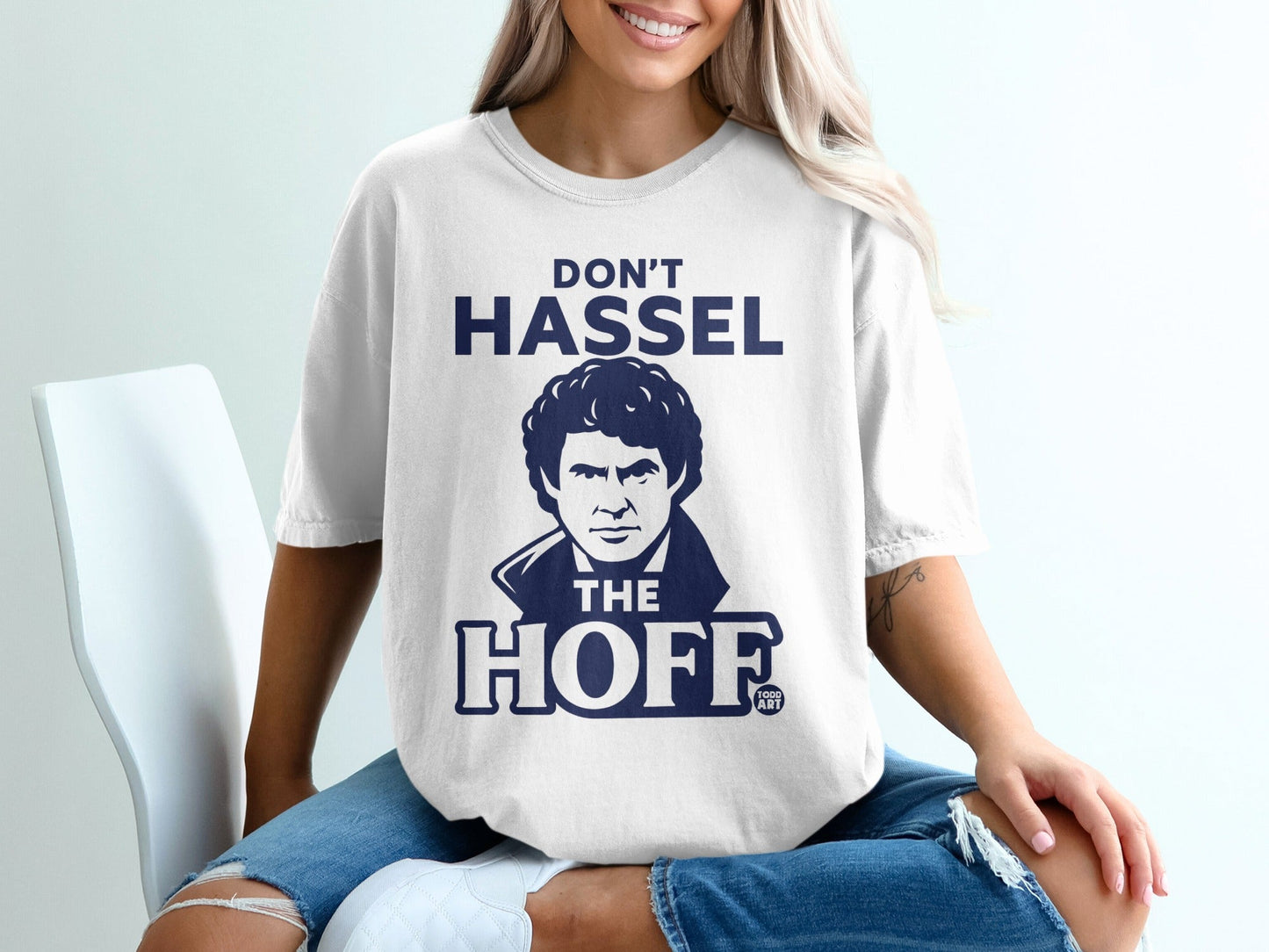 White t-shirt with a graphic of David Hasselhoff and the text "DON'T HASSEL THE HOFF".