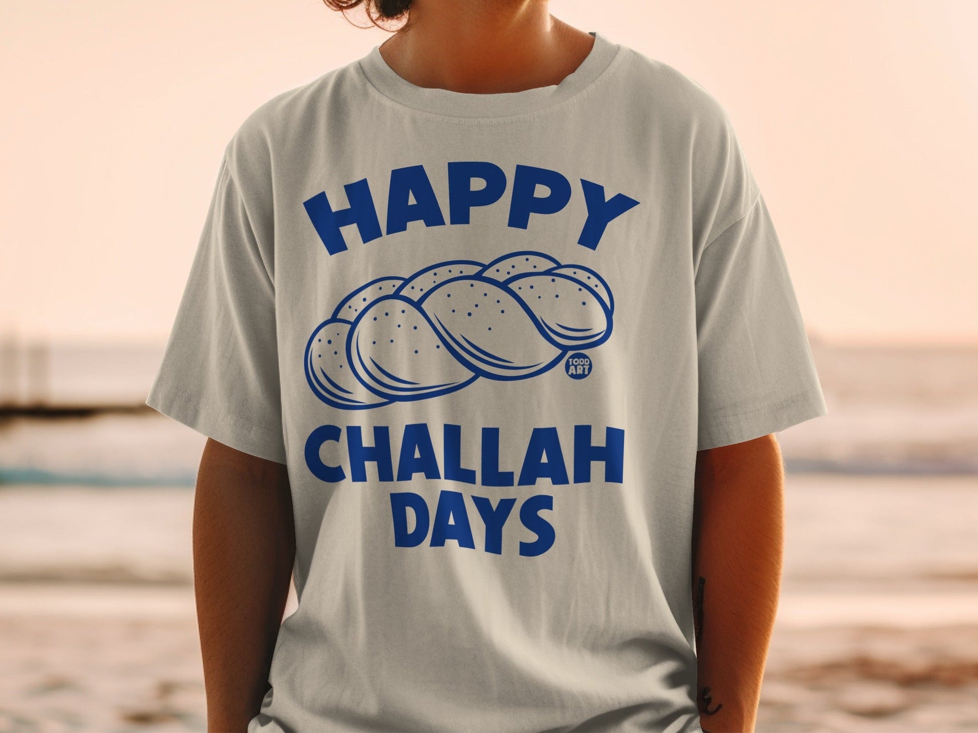 Gray t-shirt with "Happy Challah Days" text and challah bread illustration.