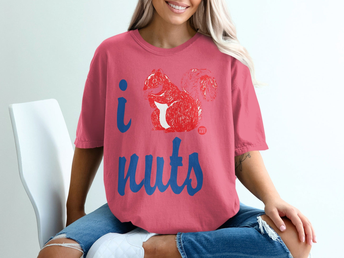 Pink t-shirt with red squirrel graphic and "I nuts" text.