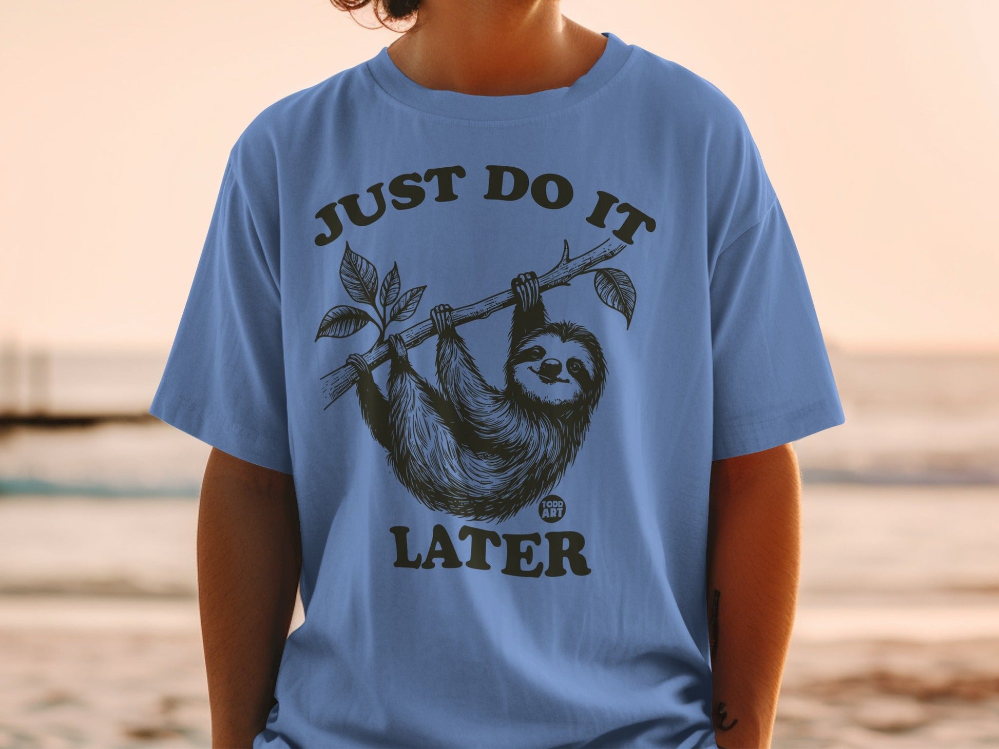 Sloth hanging from a branch with "JUST DO IT LATER" text.