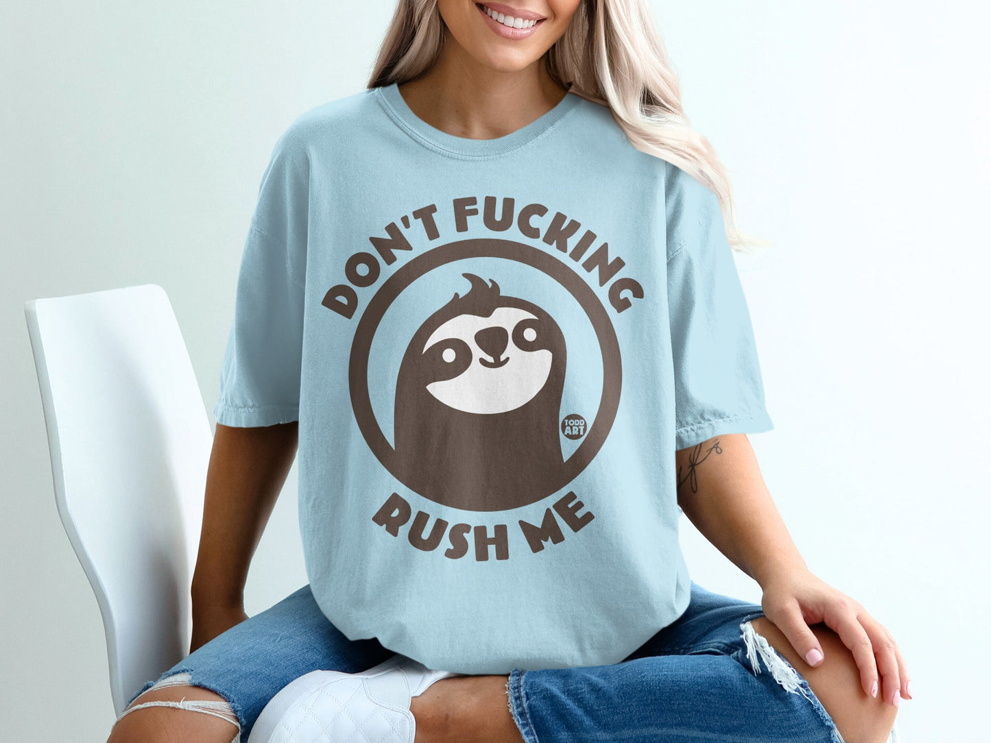 Light blue t-shirt with "Don't Fucking Rush Me" and a sloth graphic.