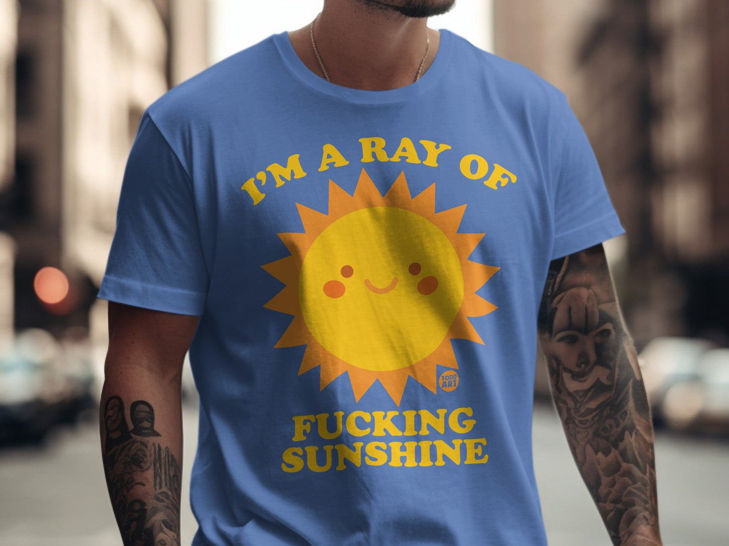 Blue t-shirt with cartoon sun graphic and "I'm a ray of fucking sunshine" text.
