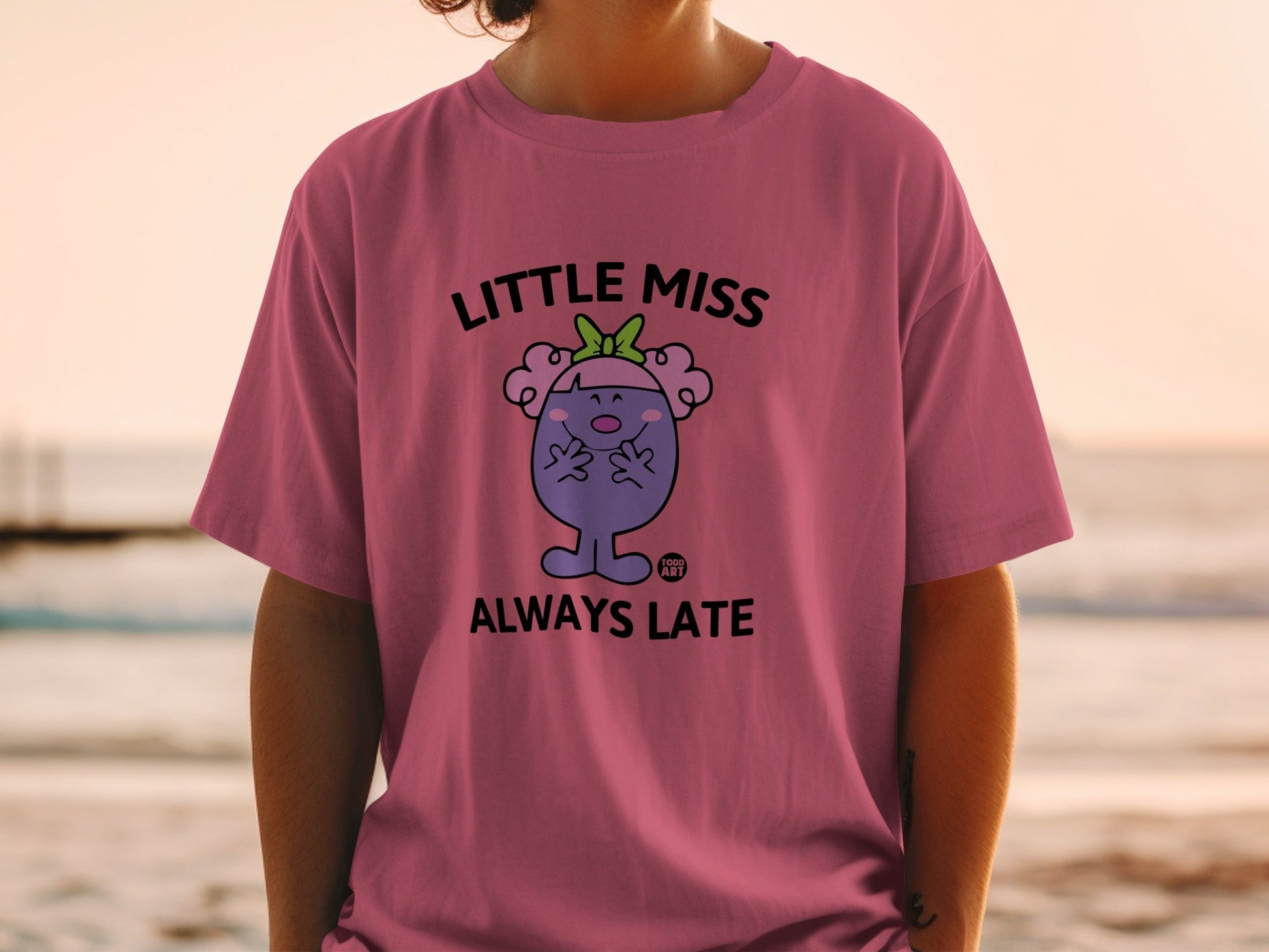 Little Miss Always Late character on a pink t-shirt.