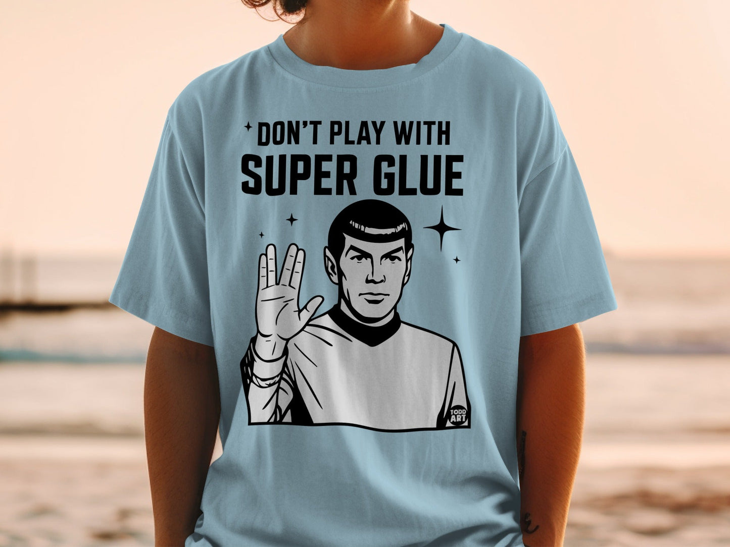 Spock from Star Trek making the Vulcan salute on a light blue t-shirt.