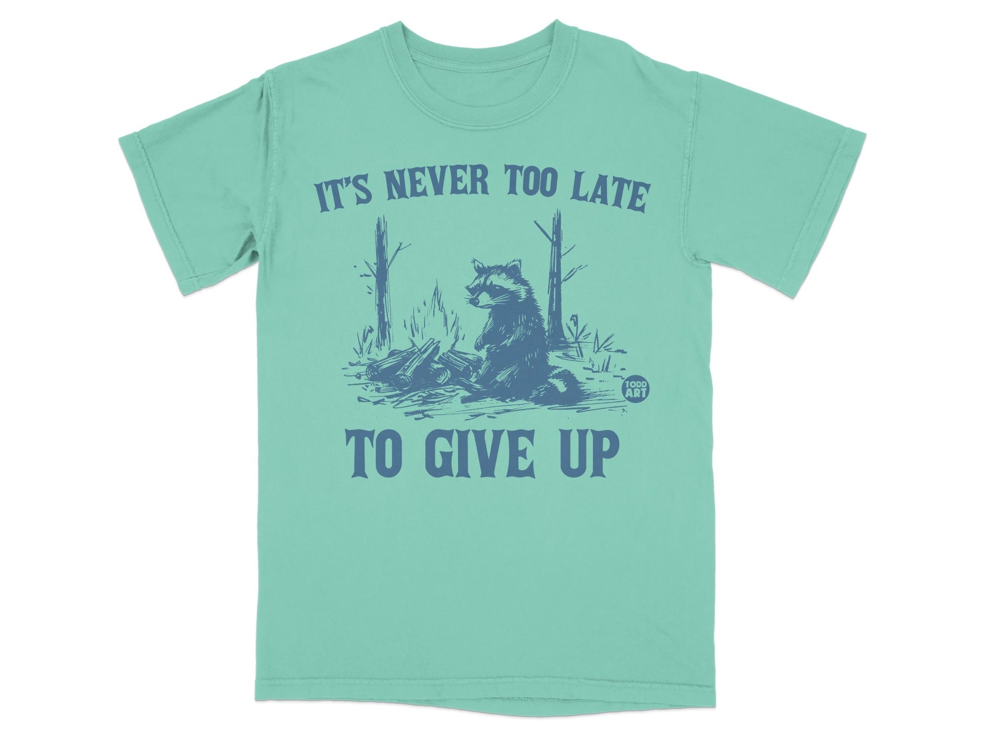 Teal t-shirt with raccoon and text "IT'S NEVER TOO LATE TO GIVE UP".