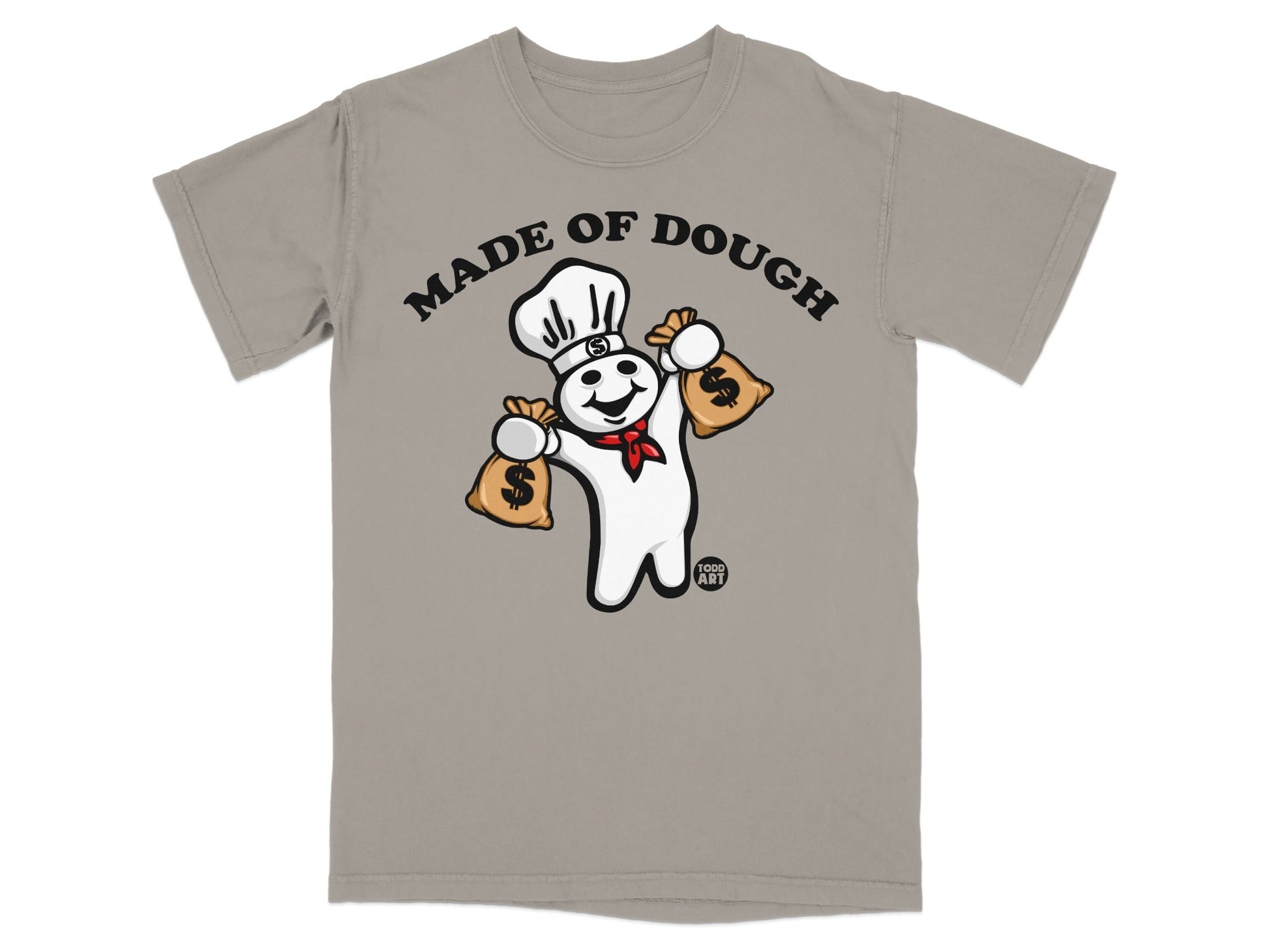 Chef character holding money bags, "Made of Dough" text on tan t-shirt.