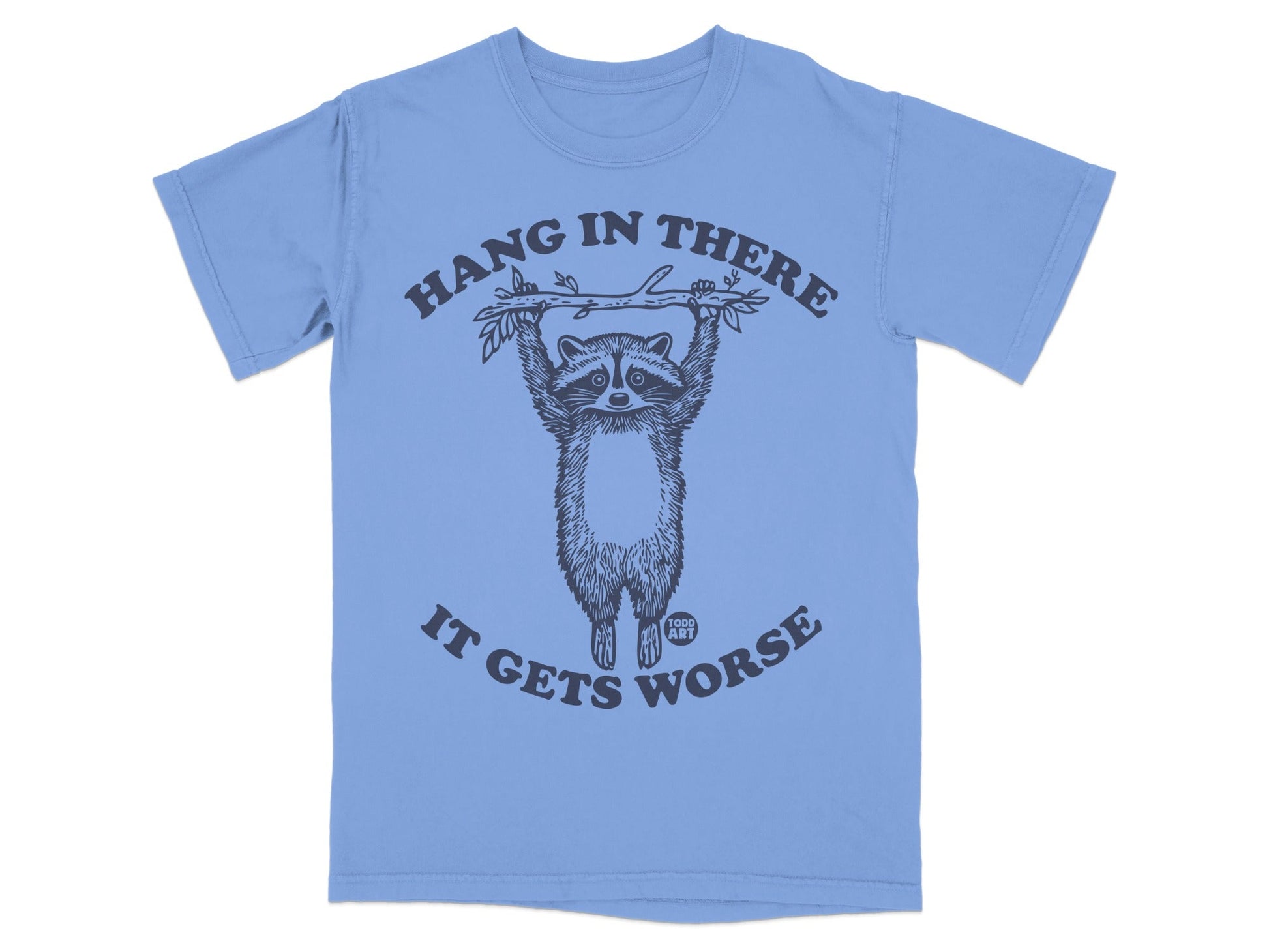 Light blue t-shirt with raccoon hanging from branch, "Hang in there it gets worse" text.