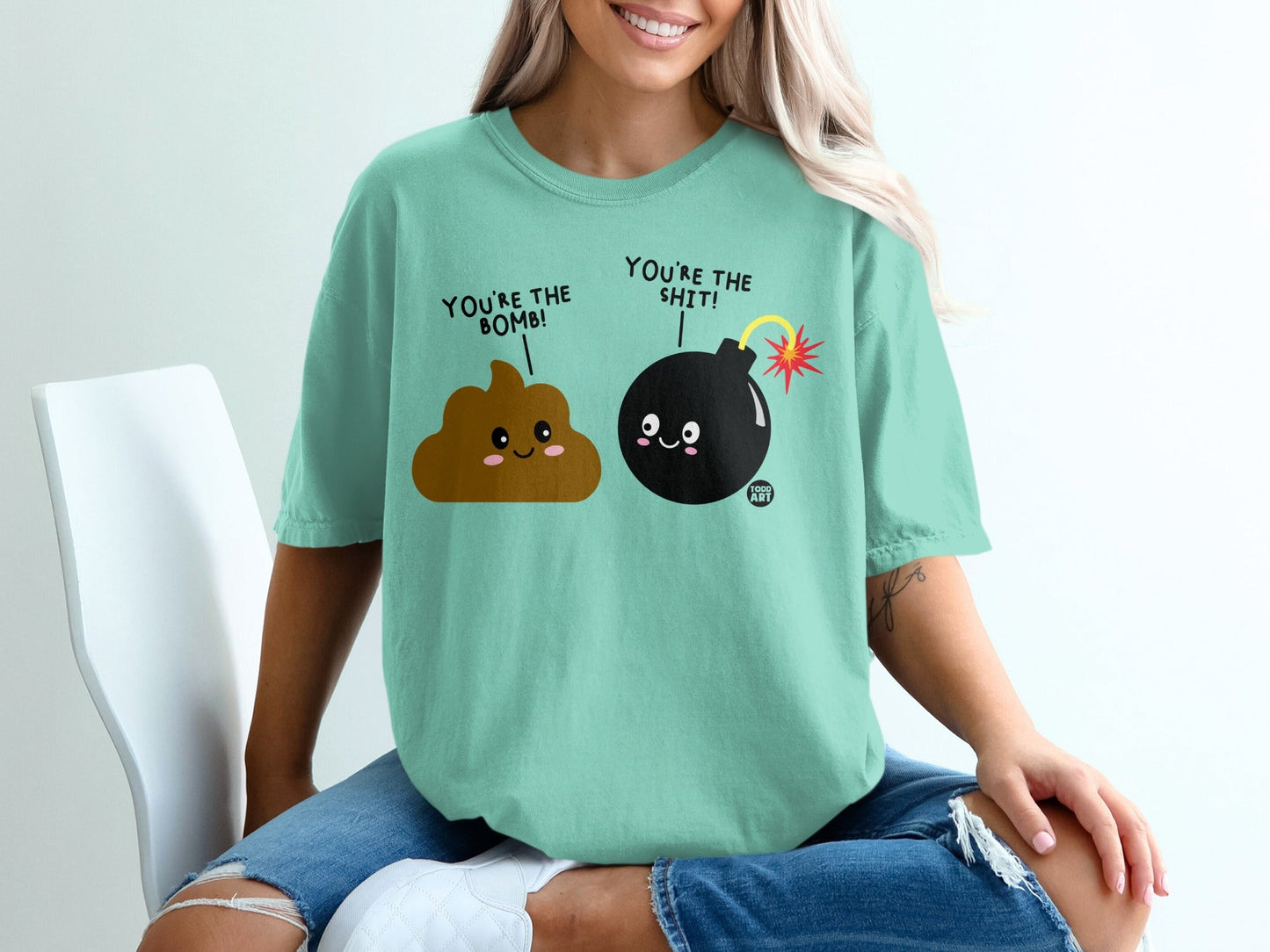 T-shirt with cartoon poop and bomb characters saying "You're the bomb!" and "You're the shit!".