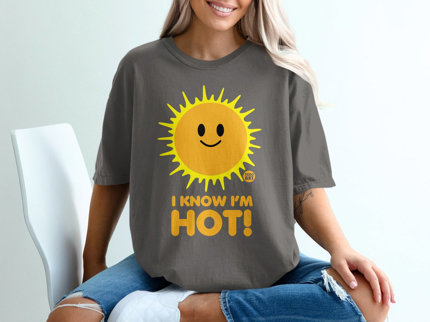 Dark gray t-shirt with a smiling sun graphic and "I KNOW I'M HOT!" text.