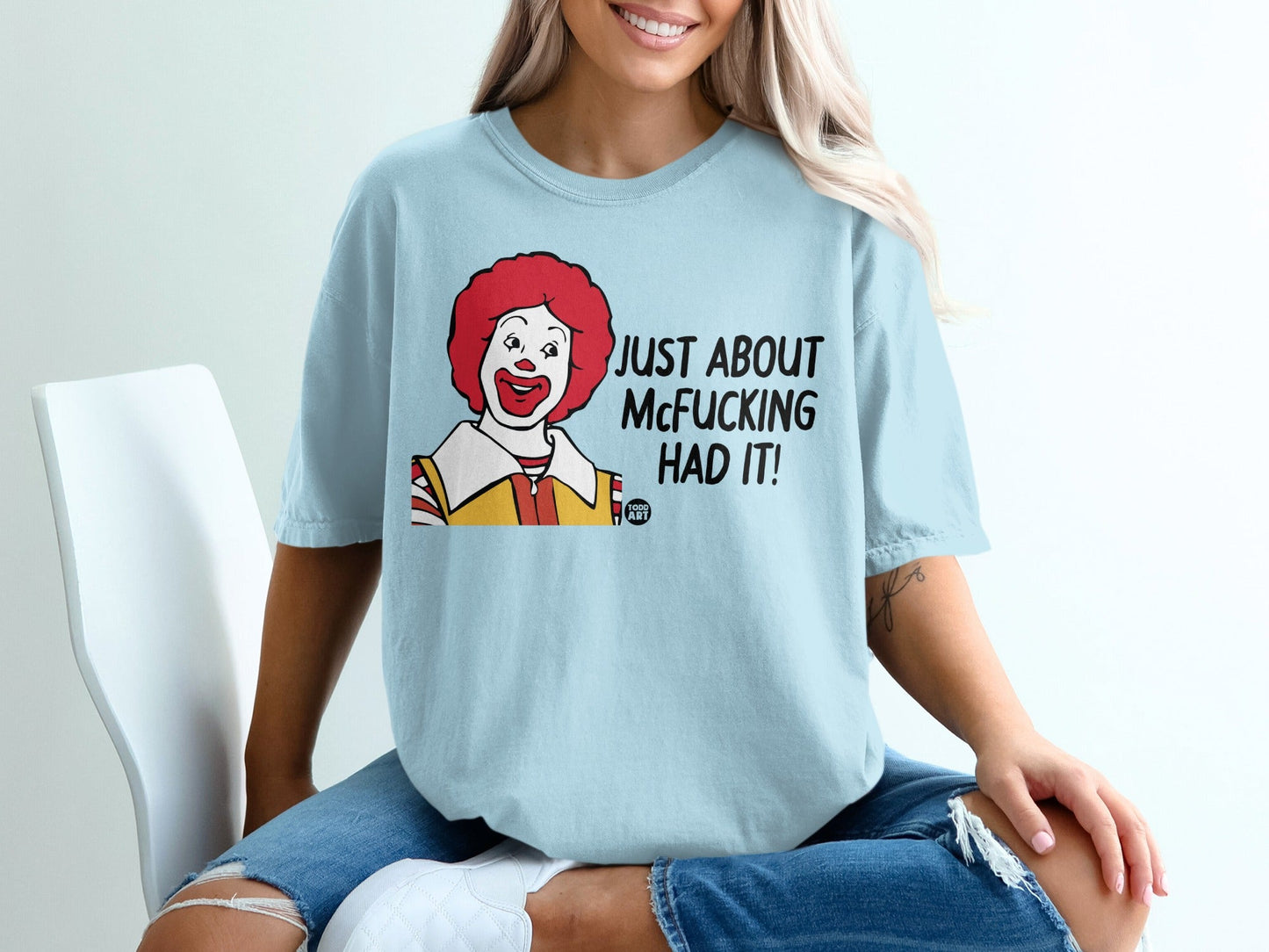 Light blue t-shirt with cartoon Ronald McDonald and text "JUST ABOUT MCF**KING HAD IT!".