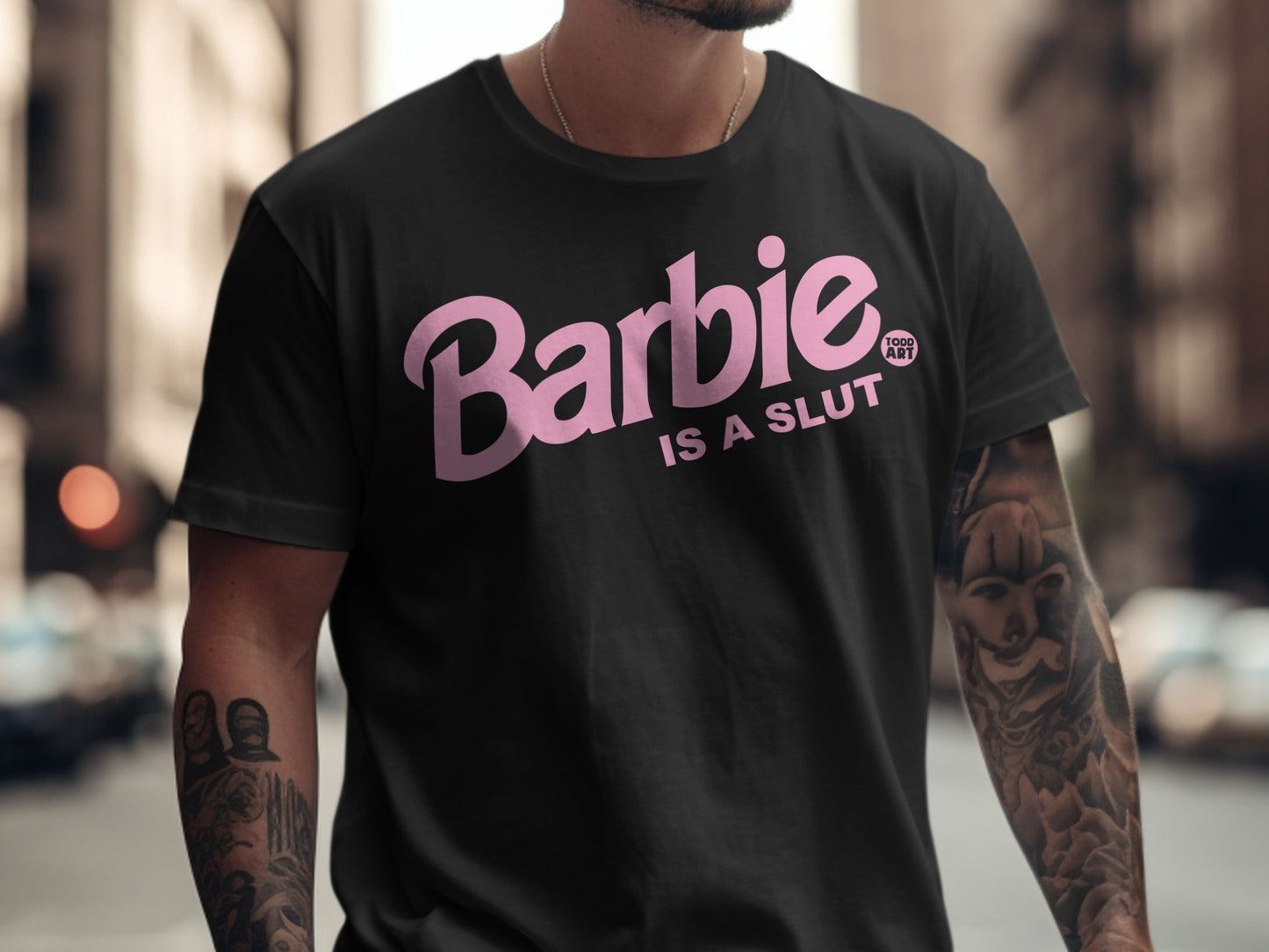 Black t-shirt with "Barbie IS A SLUT" in pink text.