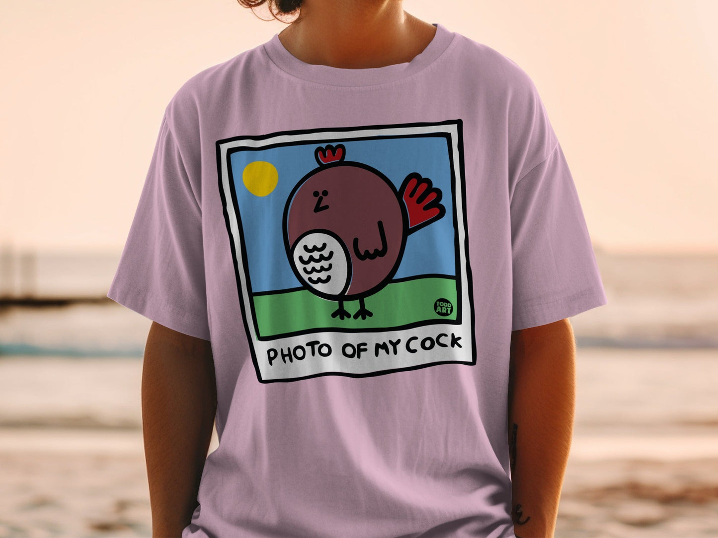 Pink t-shirt with cartoon rooster in photo frame and text "PHOTO OF MY COCK".