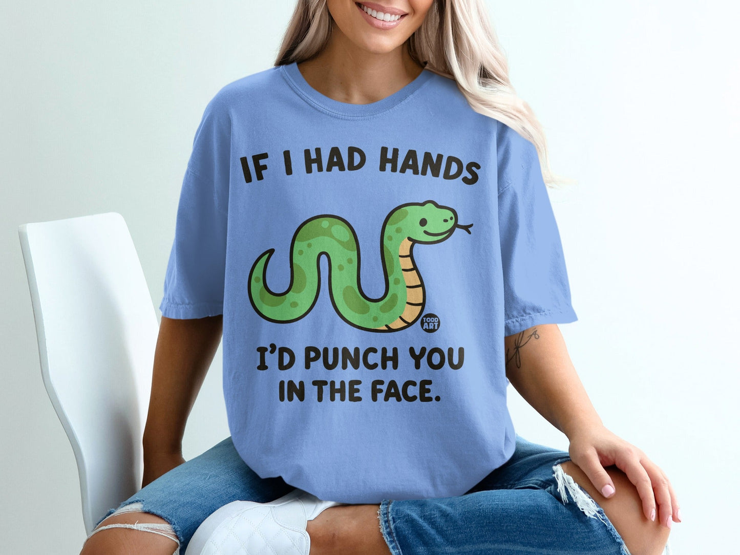 Blue t-shirt with a smiling cartoon snake and text: "If I had hands I'd punch you in the face."