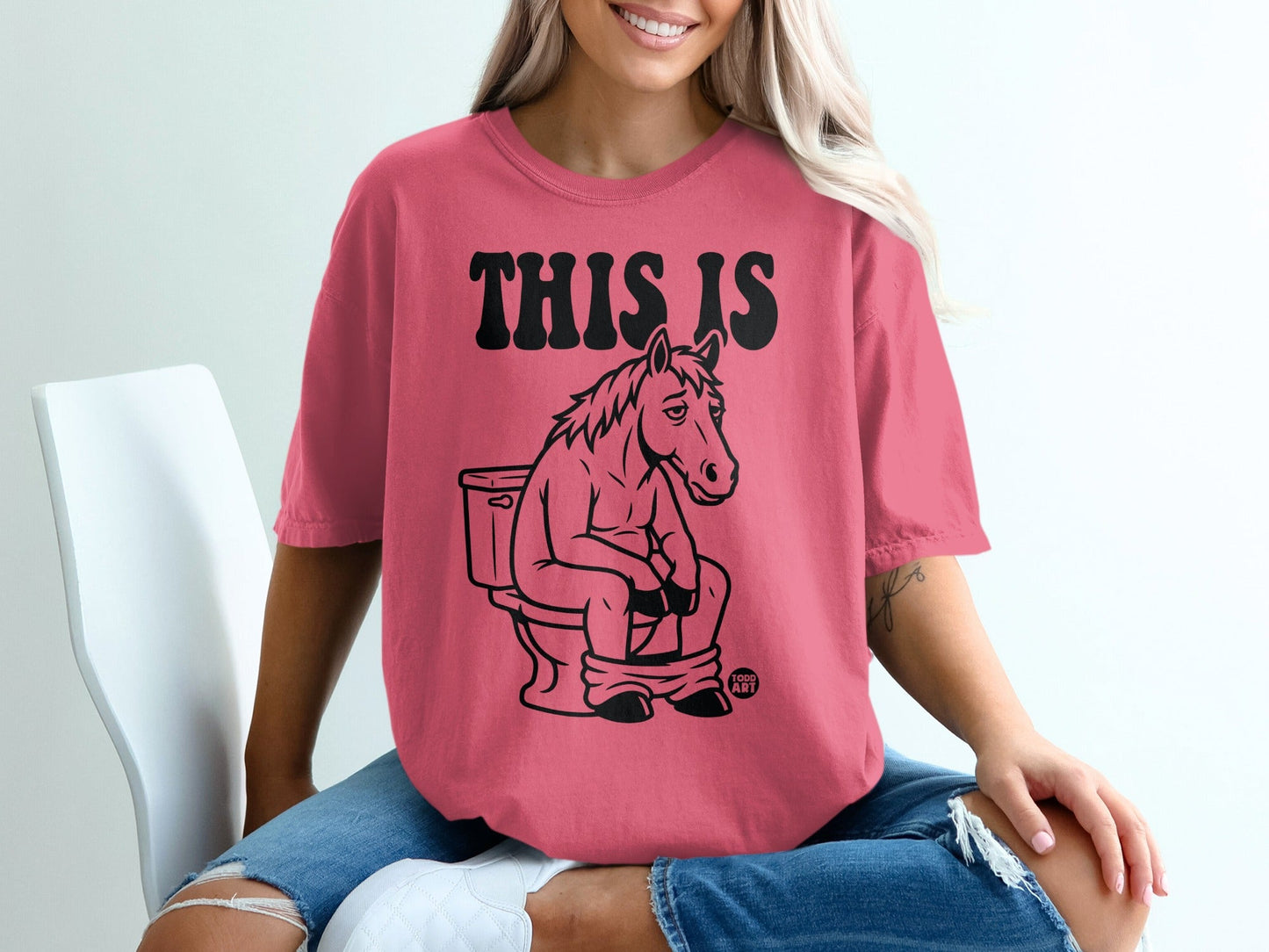 Horse sitting on toilet with text "THIS IS" above it.