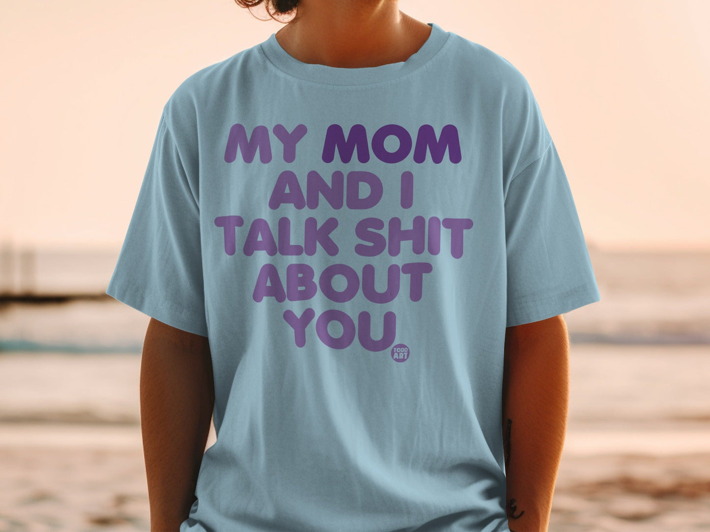 Light blue t-shirt with purple text: MY MOM AND I TALK SHIT ABOUT YOU.