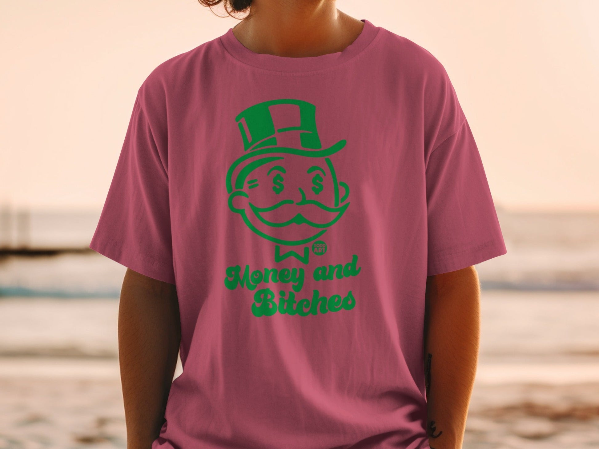 Pink t-shirt with green "Money and Bitches" text and Monopoly Man graphic.