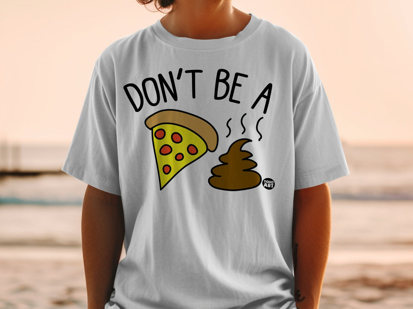 White t-shirt with pizza slice and brown poop emoji, "Don't Be A" text.