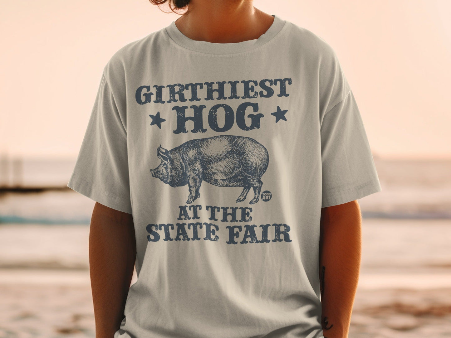 T-shirt with "Girthiest Hog at the State Fair" graphic and pig illustration.