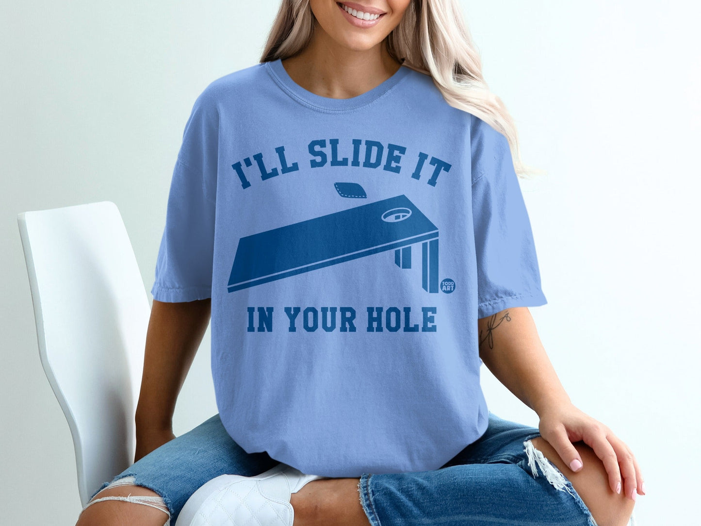 Blue t-shirt with "I'll slide it in your hole" and cornhole graphic.