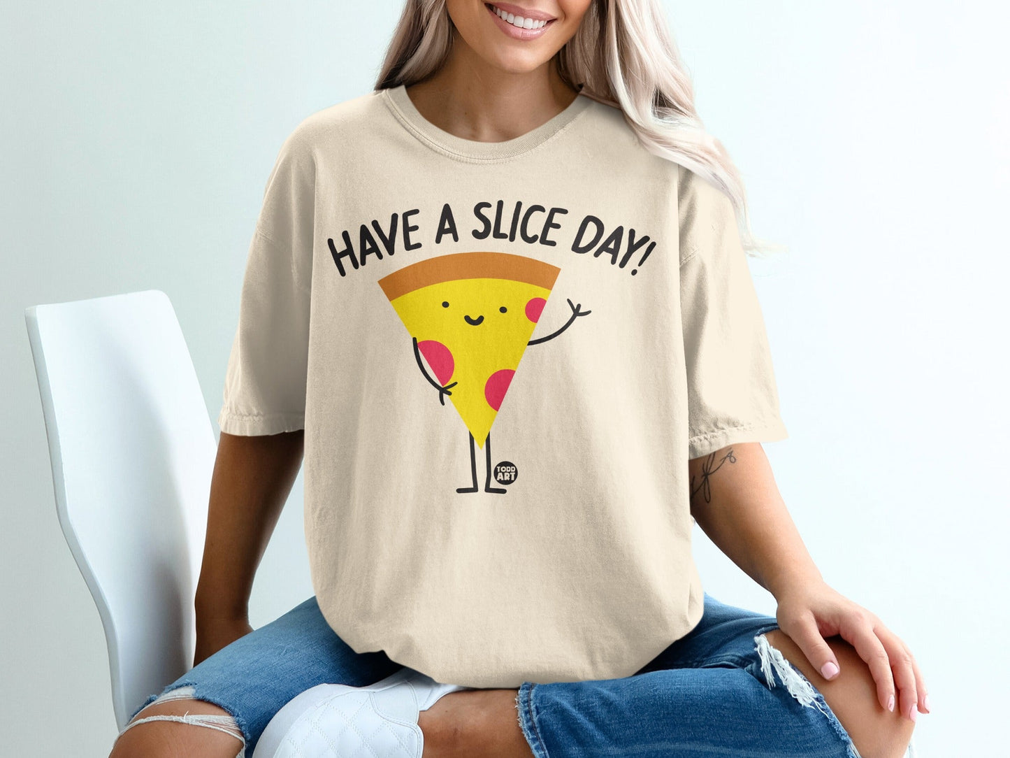 T-shirt with a cartoon slice of pizza saying "Have a Slice Day!".