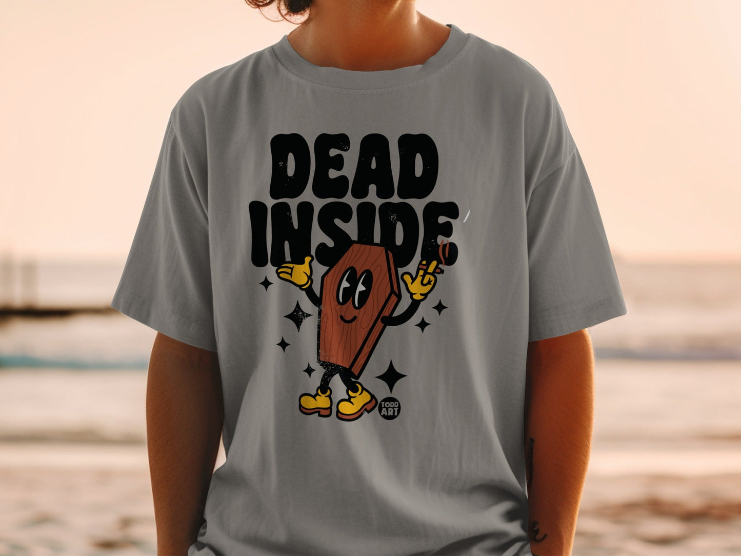 T-shirt with cartoon coffin character that says "DEAD INSIDE" and holds a cigarette.