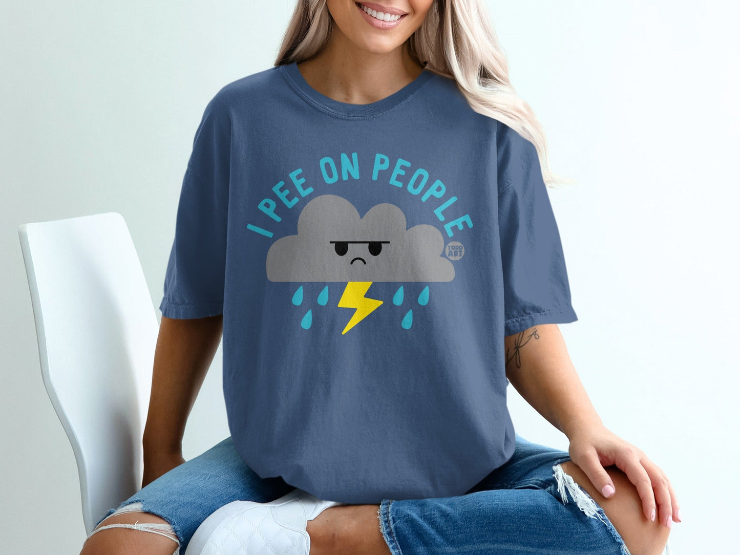 T-shirt with grumpy cloud design, yellow lightning, and "I PEE ON PEOPLE" text.