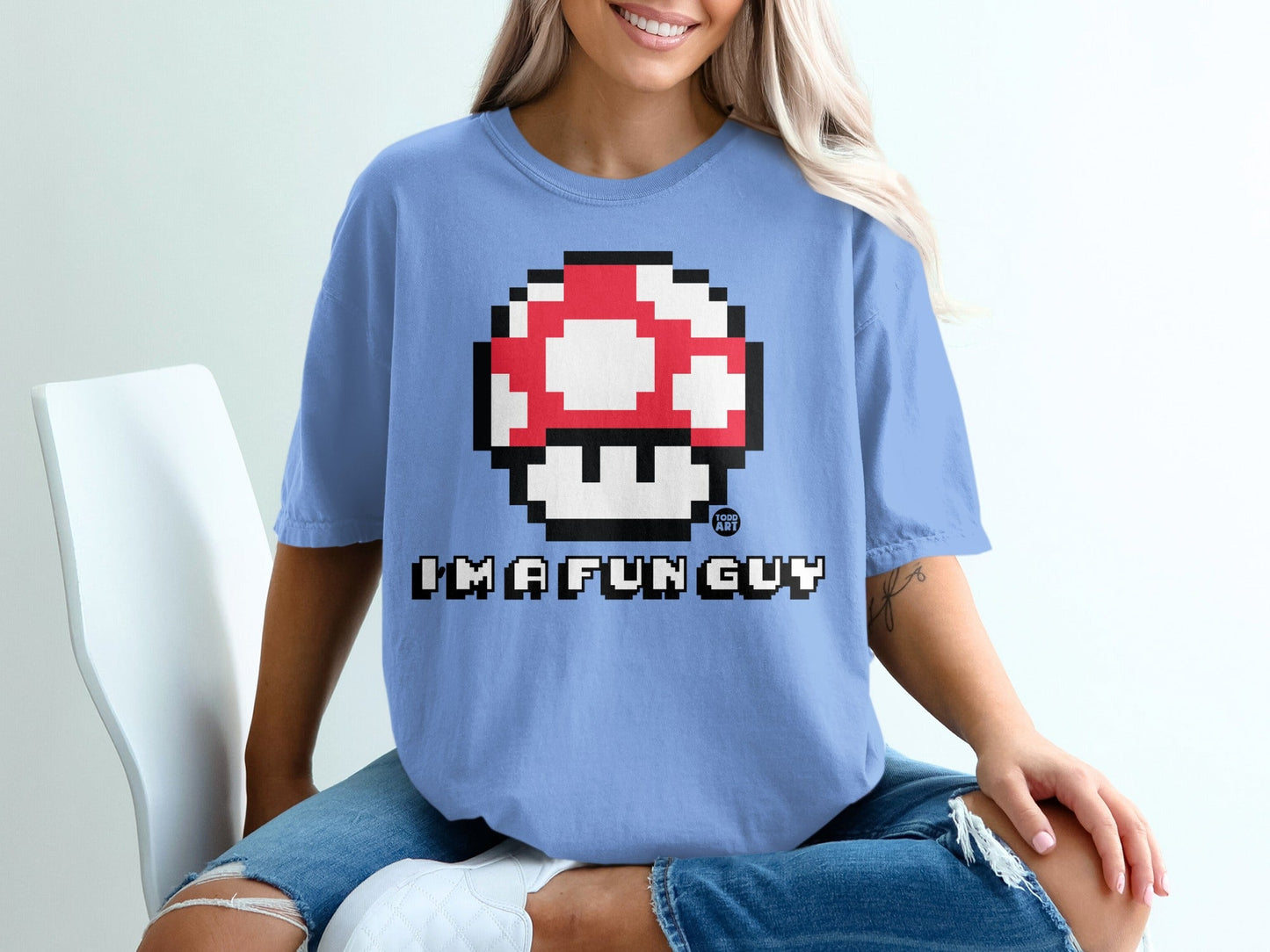 Light blue t-shirt with pixelated red and white mushroom and "I'M A FUN GUY" text.