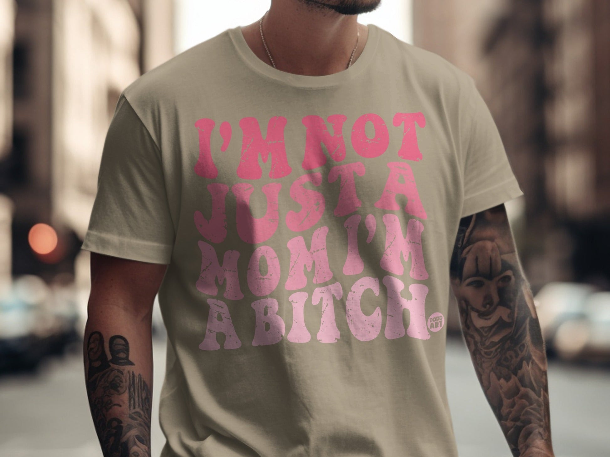 Tan t-shirt with pink text "I'm not just a mom I'm a bitch".