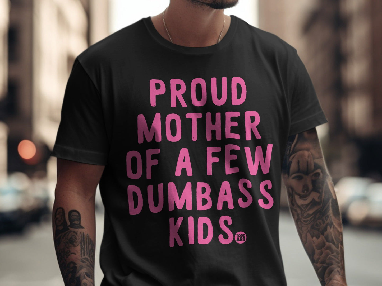 Black t-shirt with "Proud Mother of a Few Dumbass Kids" in pink text.
