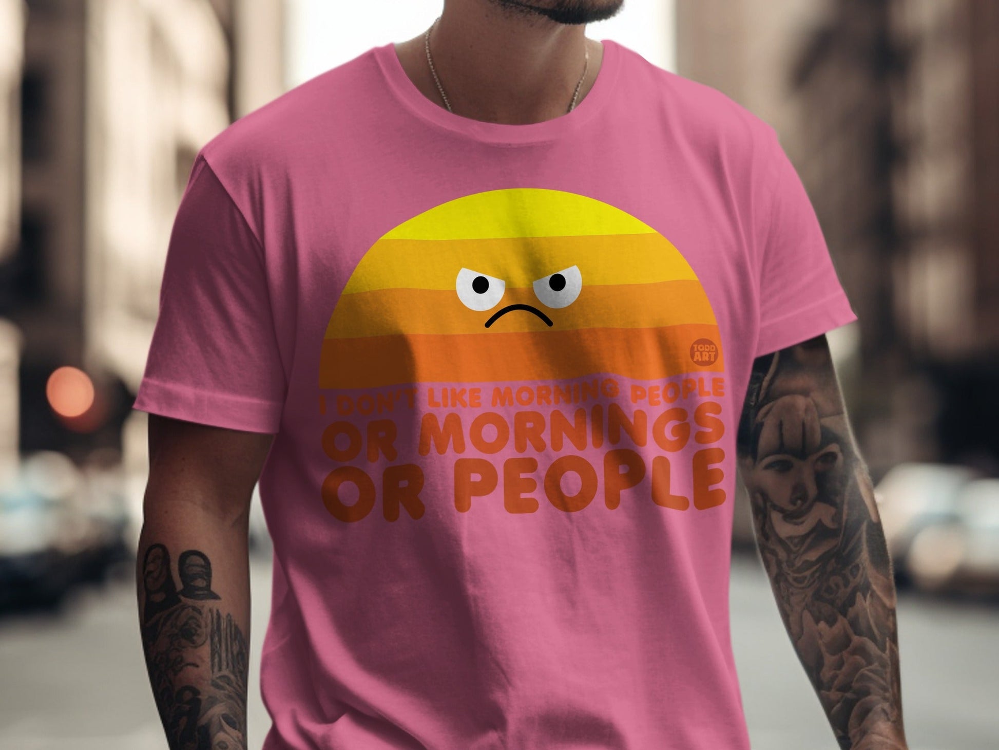 Pink t-shirt with cartoon sun and text: "I don't like morning people or mornings or people."