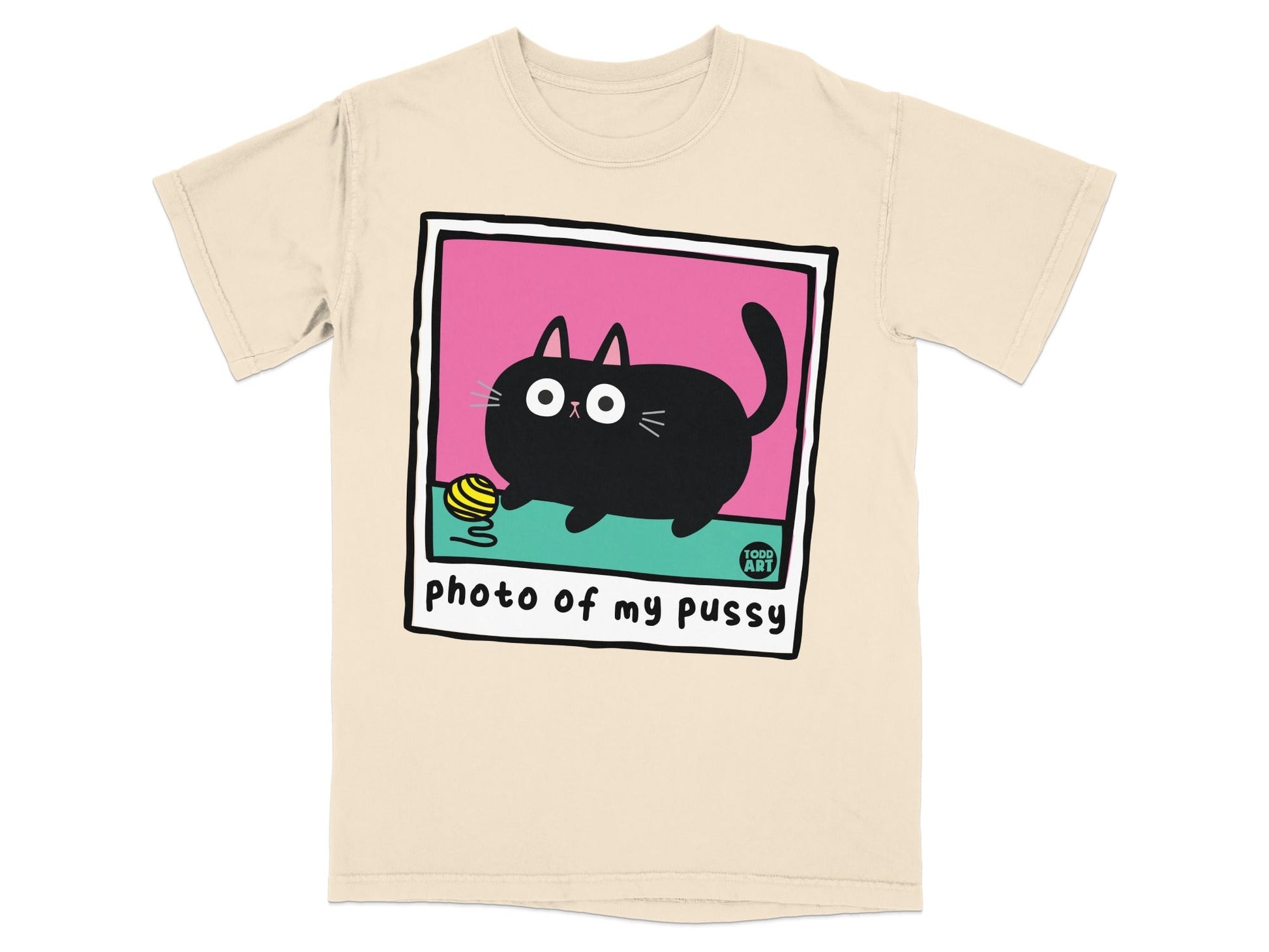 Cream t-shirt with a cartoon black cat and yarn in a polaroid frame.