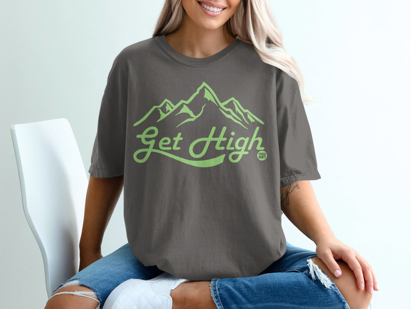 T-shirt with "Get High" text and mountain graphic in light green.
