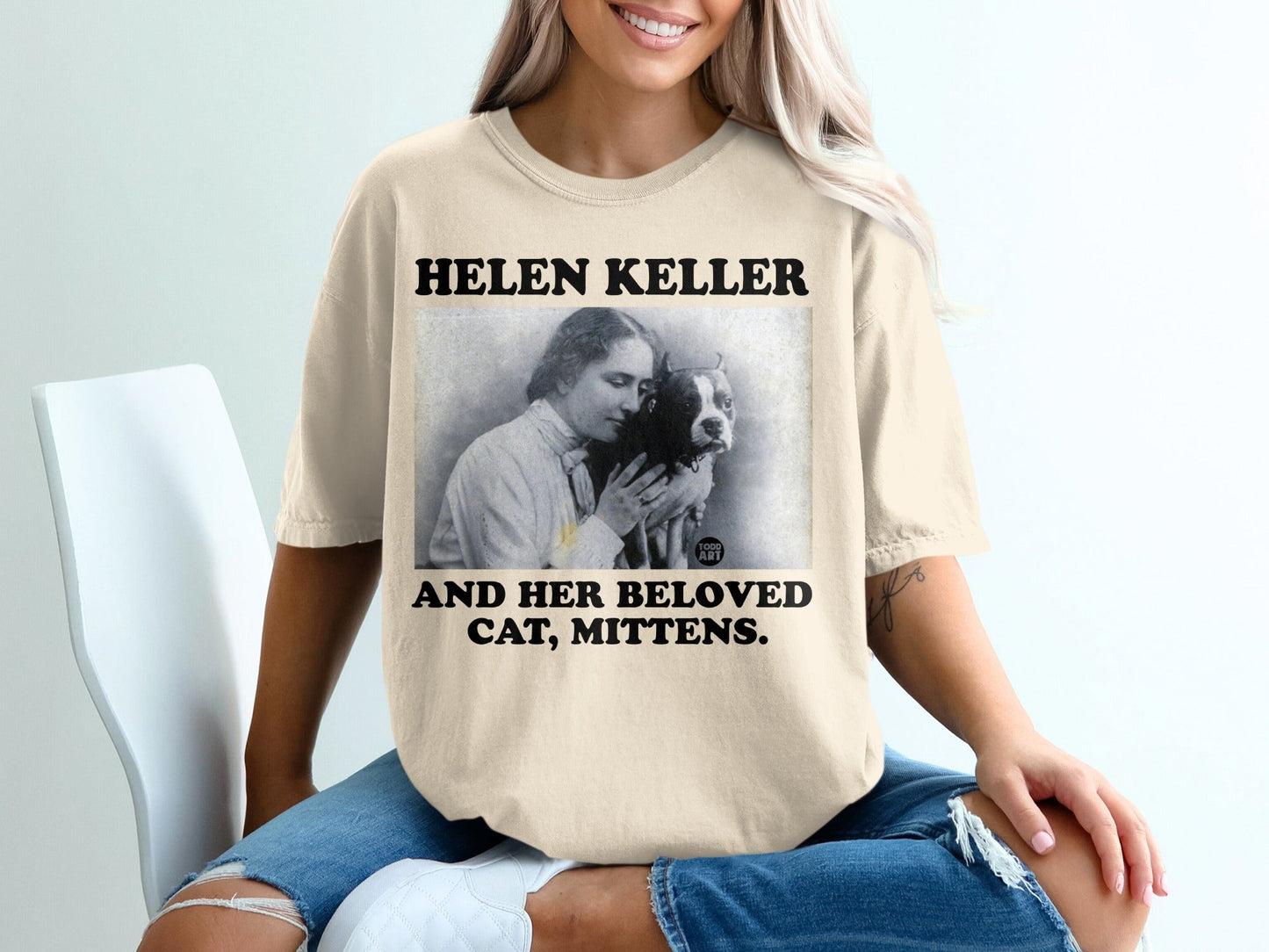 T-shirt with "HELEN KELLER AND HER BELOVED CAT, MITTENS." and vintage portrait.