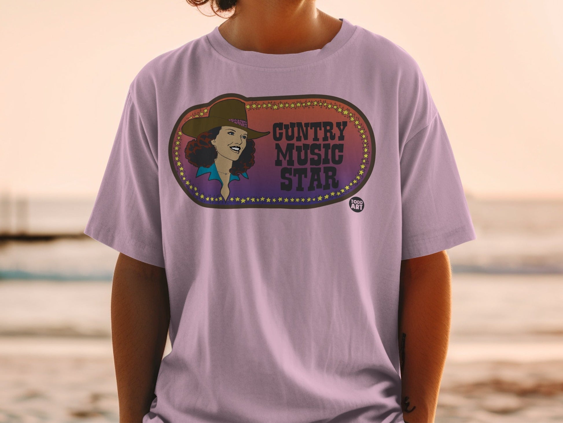 T-shirt with a graphic of a smiling woman in a hat, with "Cuntry Music Star" text.