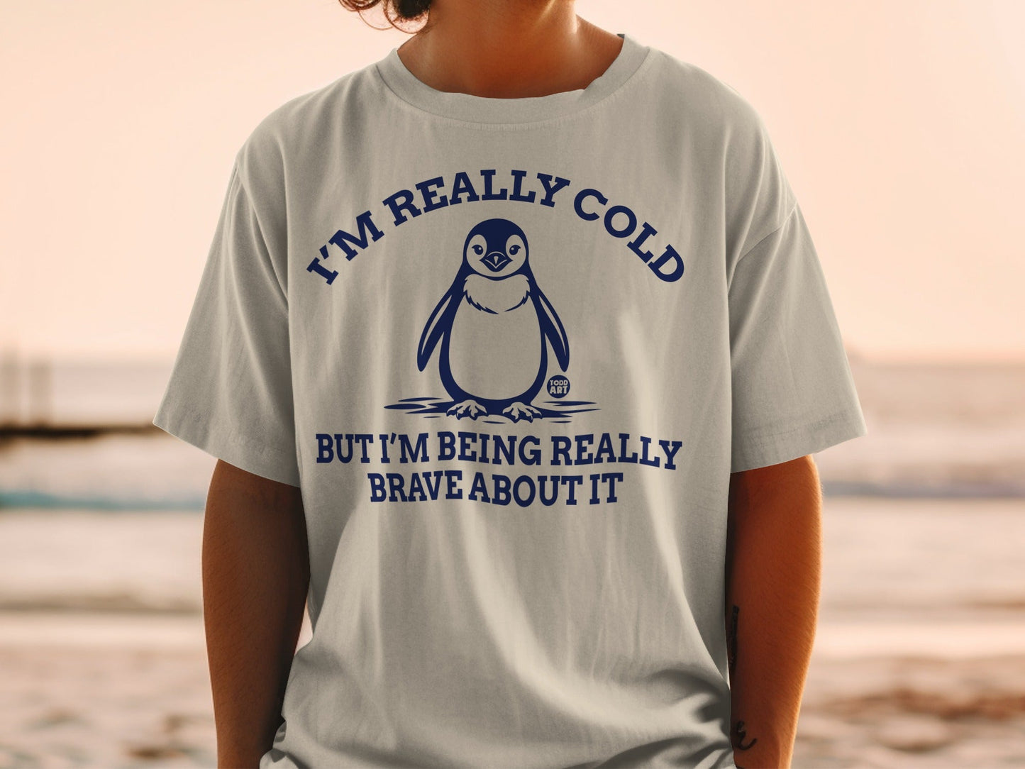 T-shirt with penguin graphic and text "I'M REALLY COLD BUT I'M BEING REALLY BRAVE ABOUT IT".