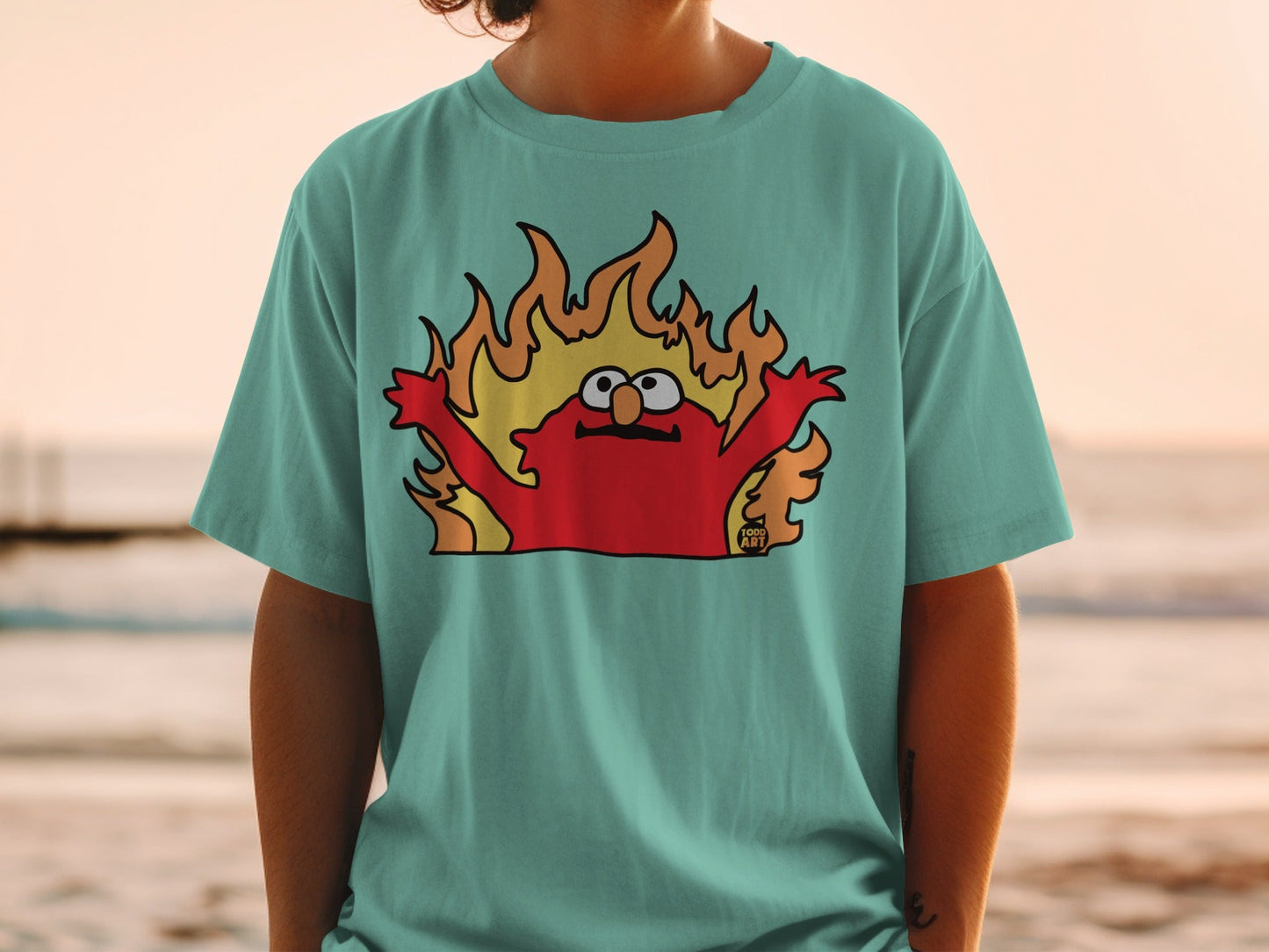 Elmo on a t-shirt engulfed in flames.
