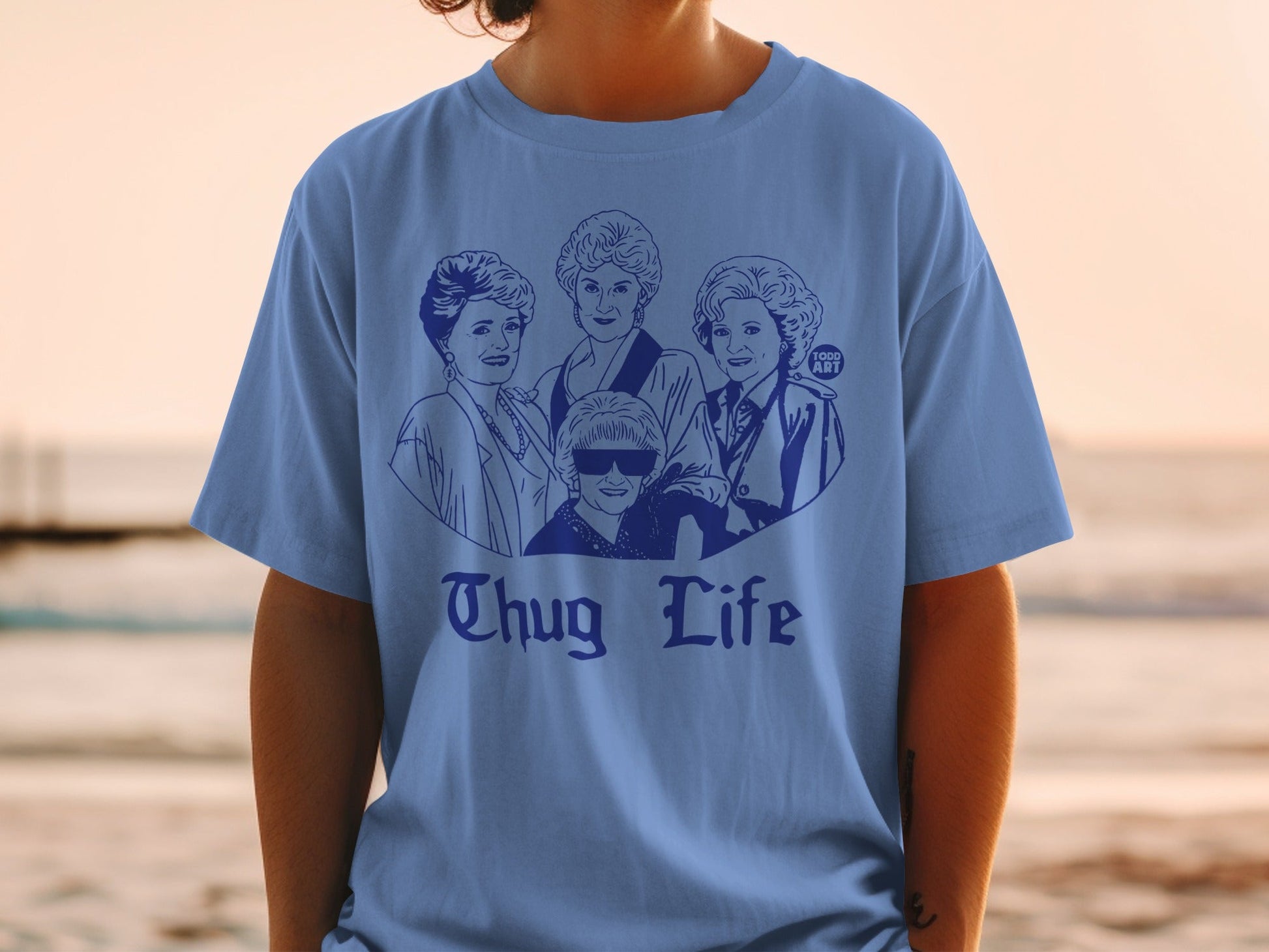 Blue t-shirt featuring a sketch of the Golden Girls with "Thug Life" text.