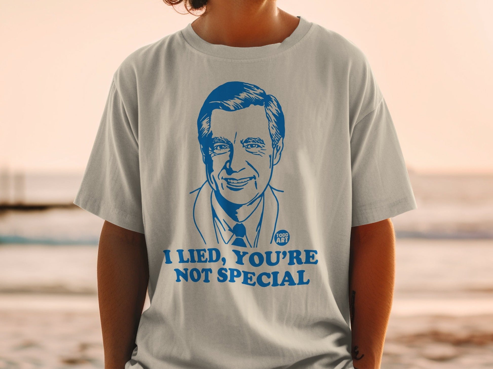 T-shirt with blue illustration of Fred Rogers and text "I LIED, YOU'RE NOT SPECIAL."