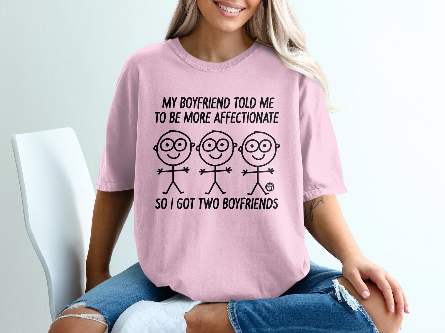 Pink t-shirt with stick figures and text "My boyfriend told me to be more affectionate so I got two boyfriends".