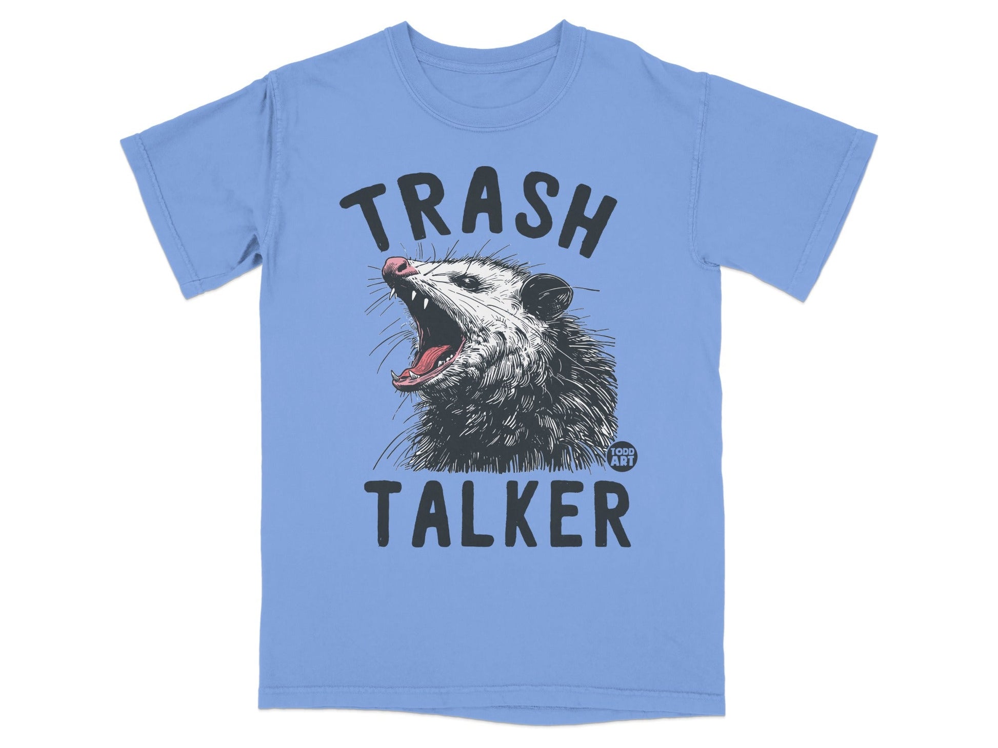 Light blue t-shirt with a graphic of a possum yelling and the text "TRASH TALKER".