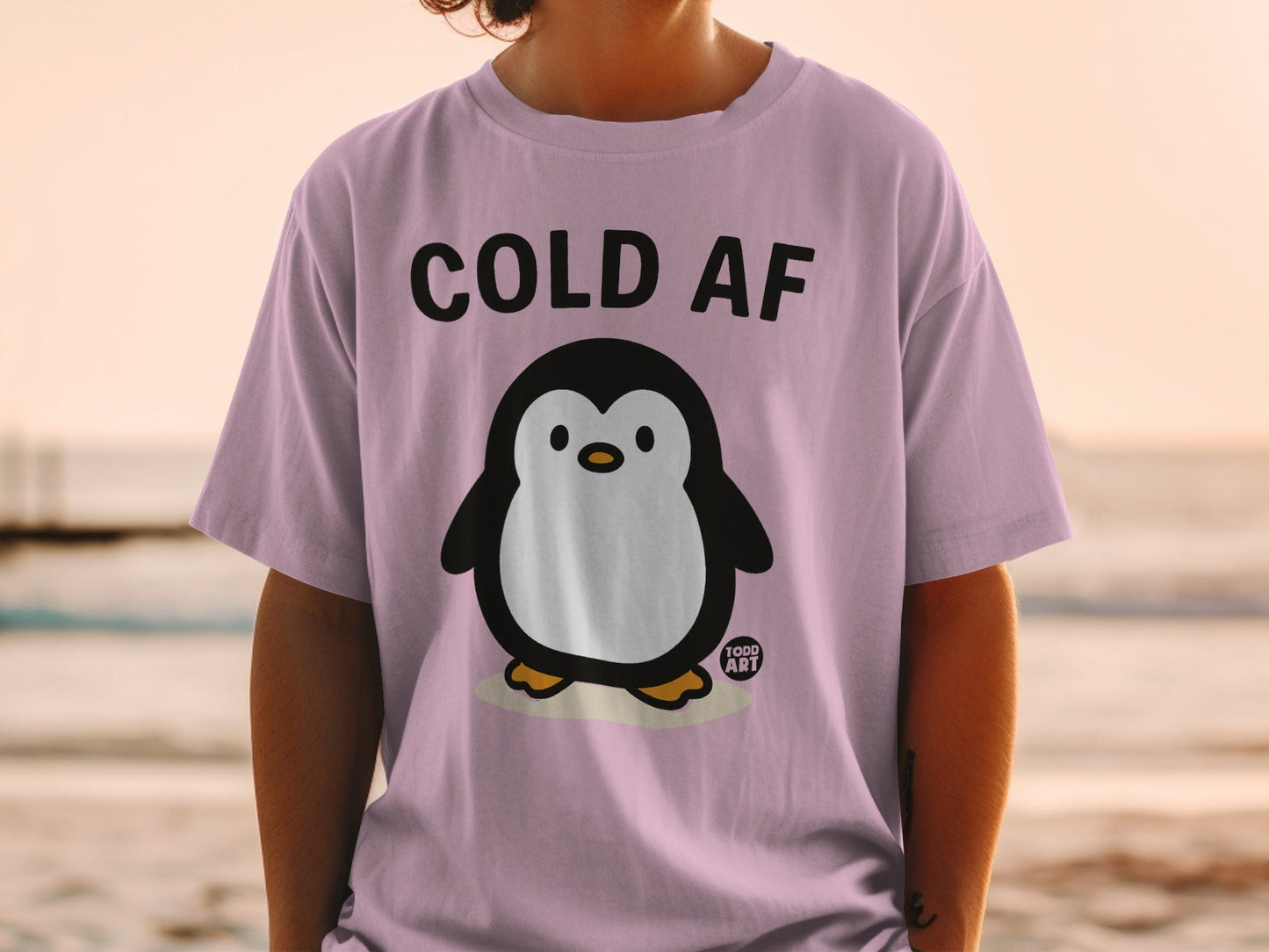 Purple t-shirt with a cartoon penguin and "COLD AF" text.