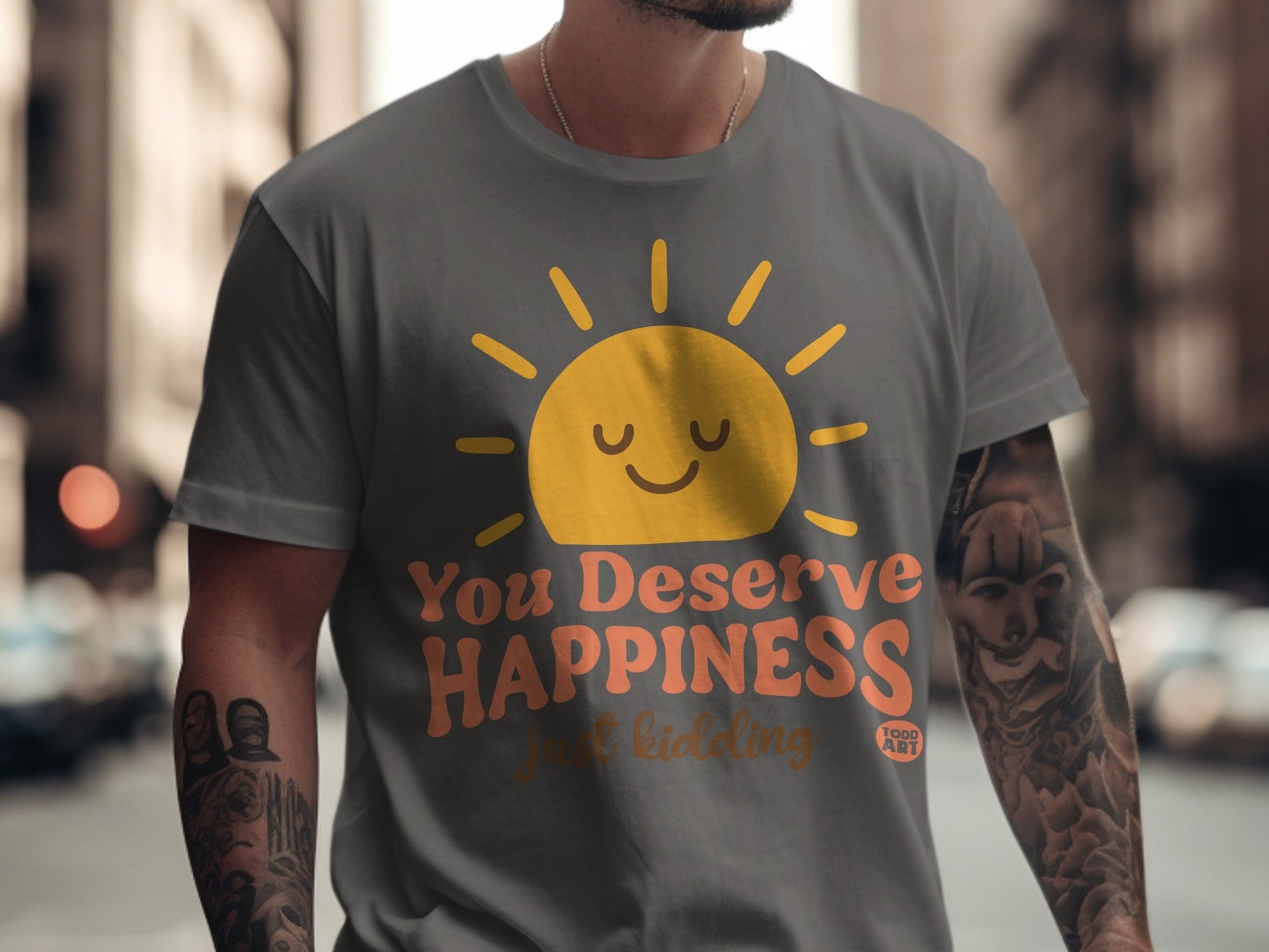 Grey t-shirt with a smiling sun graphic and text "You Deserve Happiness just kidding"