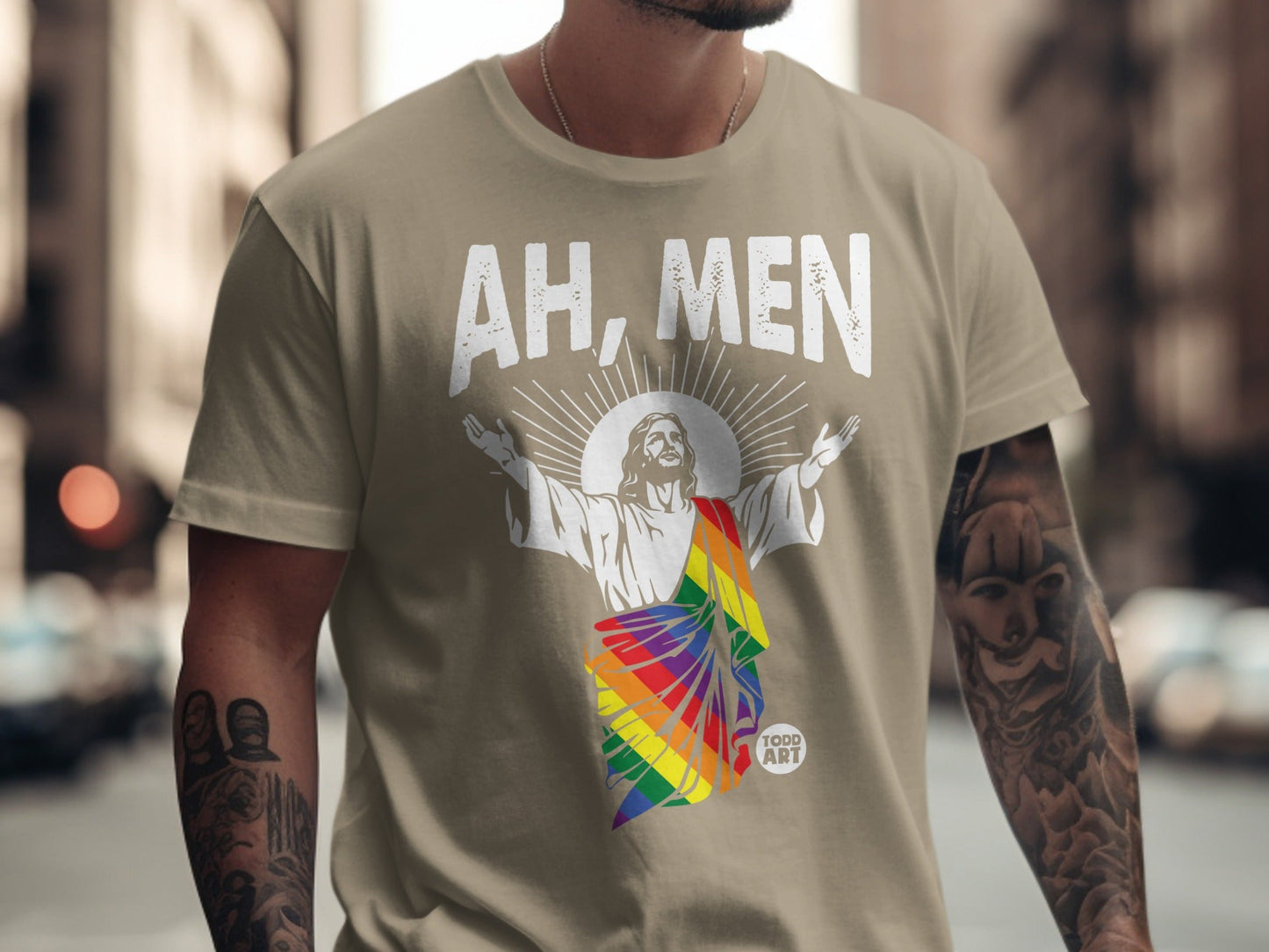 T-shirt with Jesus in rainbow stole, text "AH, MEN" and "TODD ART" logo.